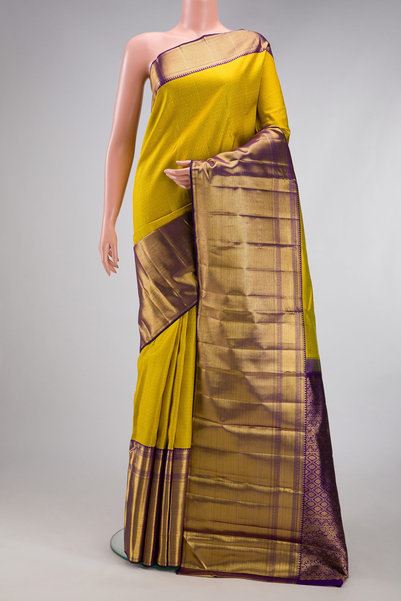 Yellow Kanchipuram Silk Saree with Zari Butta on the body and Fancy Border.  displayed on a mannequin