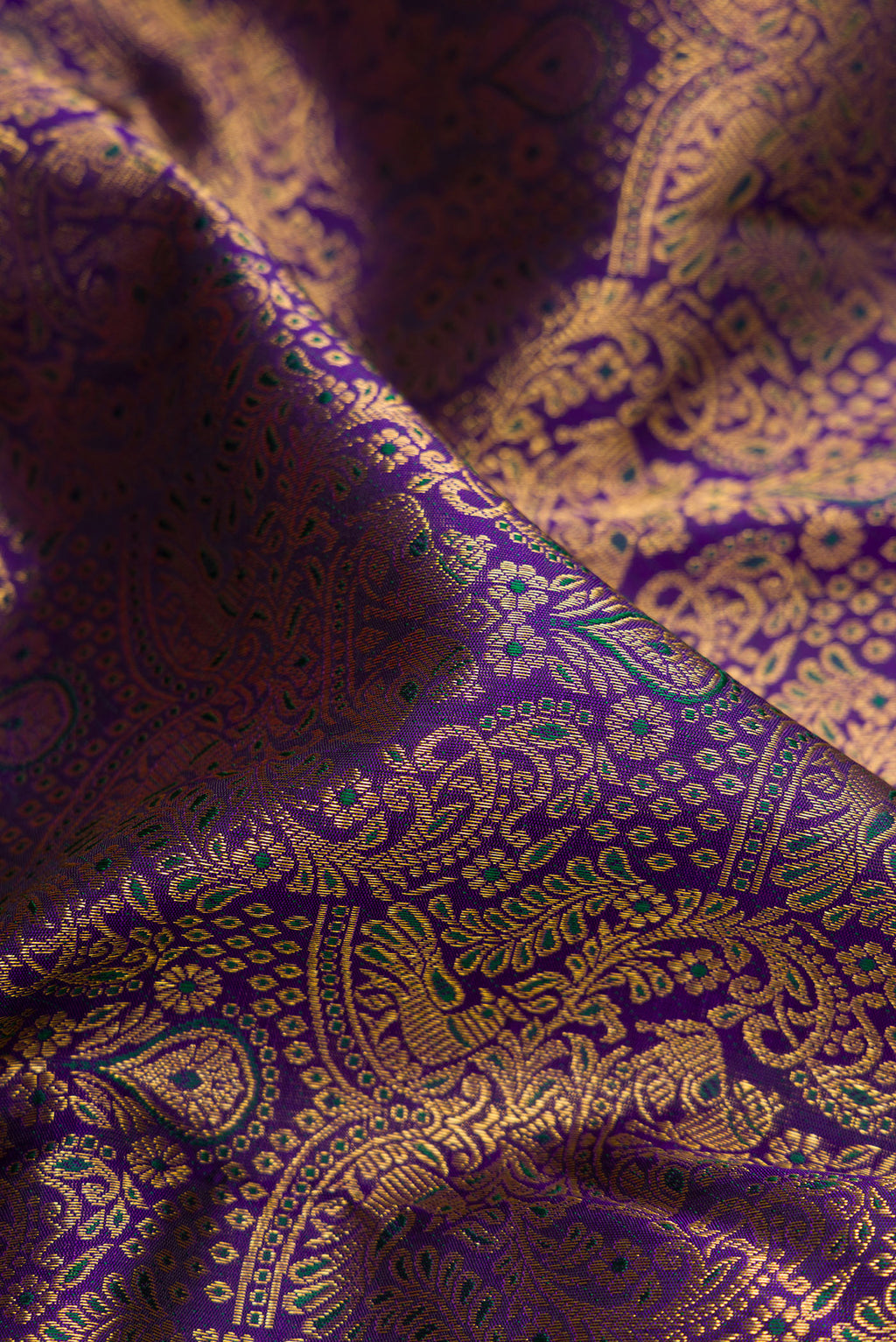 Close up of Navy Blue Dual Tone Kanchipuram Silk Saree with Zari Brocade on the body and Fancy Border.  displaying folds