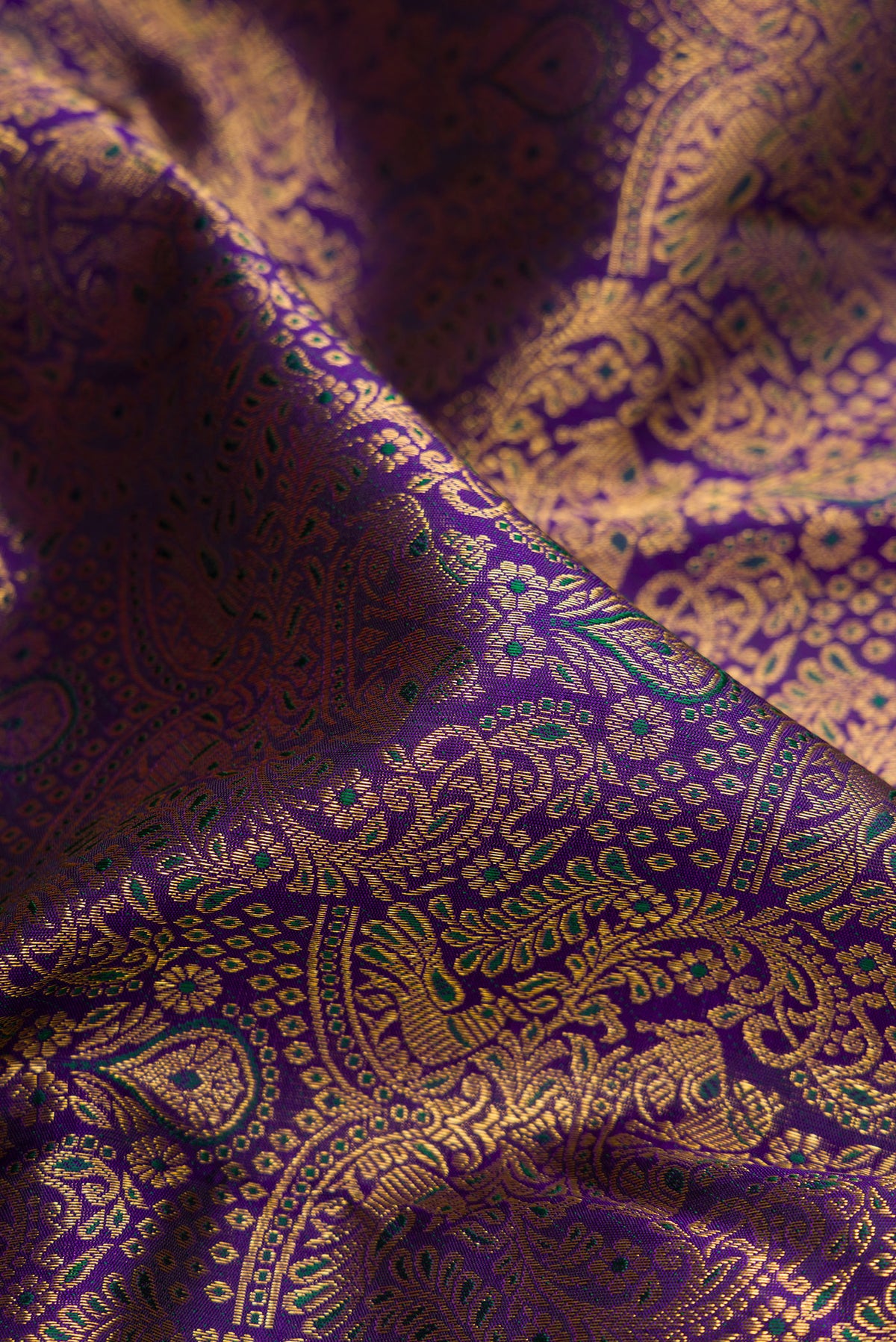 Close up of Navy Blue Dual Tone Kanchipuram Silk Saree with Zari Brocade on the body and Fancy Border.  displaying folds