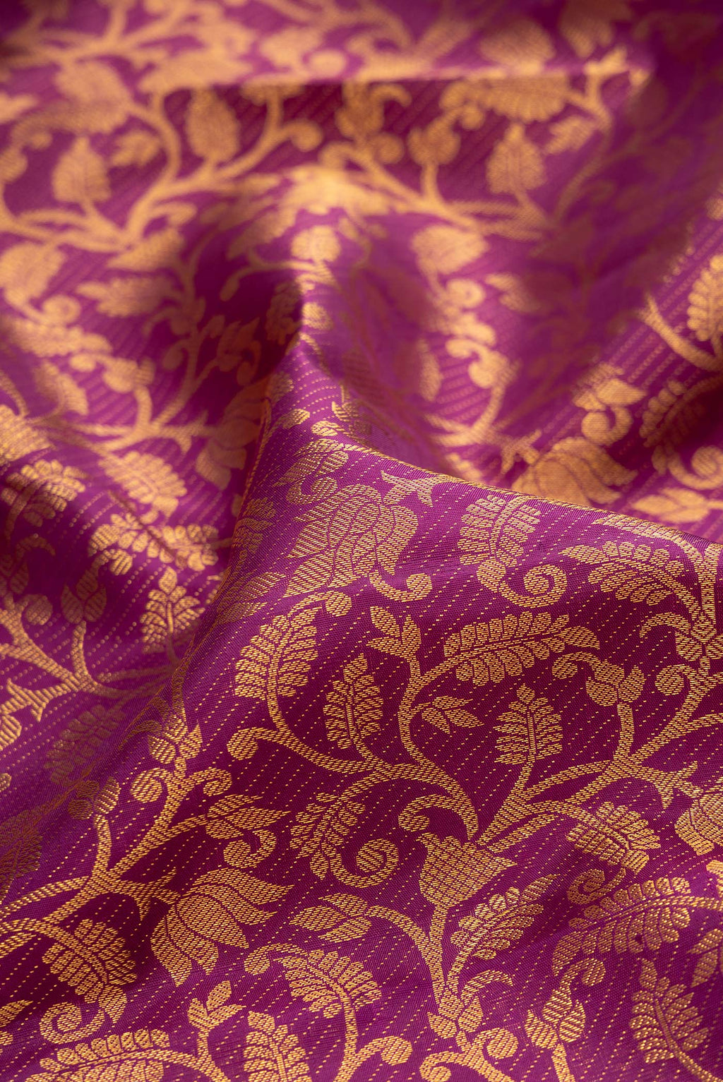 Close up of Purple Kanchipuram Silk Saree with Zari Brocade on the body and Zari Border.  displaying folds