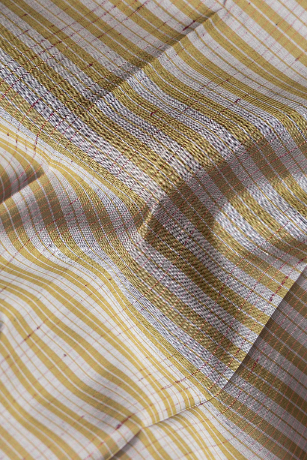 Close up of Pure Silk Grey Dual Tone Kanchipuram Saree with Checked design on the body and Zari Border.  displaying folds
