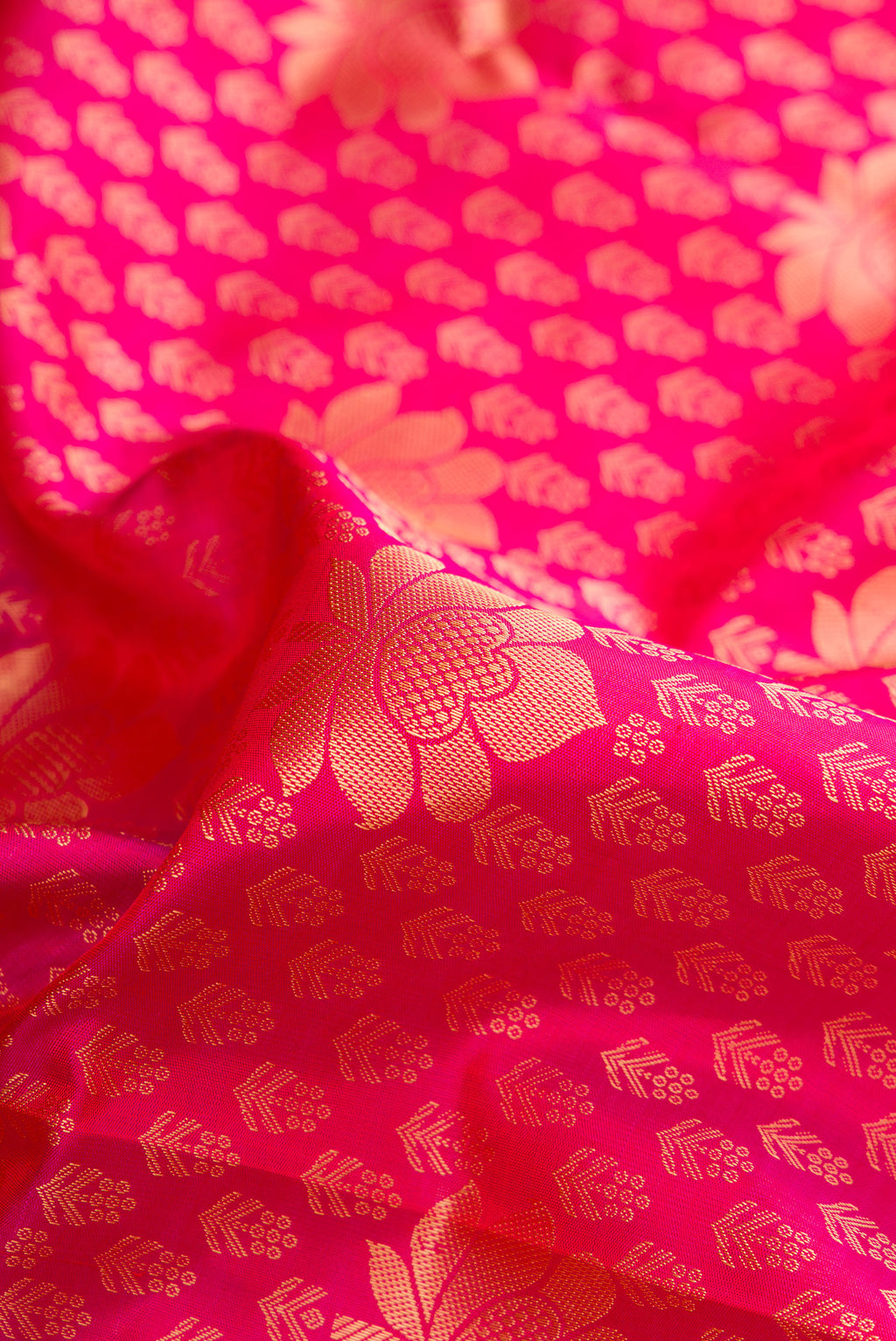 Close up of Pure Silk Pink Kanjivaram Saree with Jacquard With Zari Butta on the body and Zari Border.  displaying folds