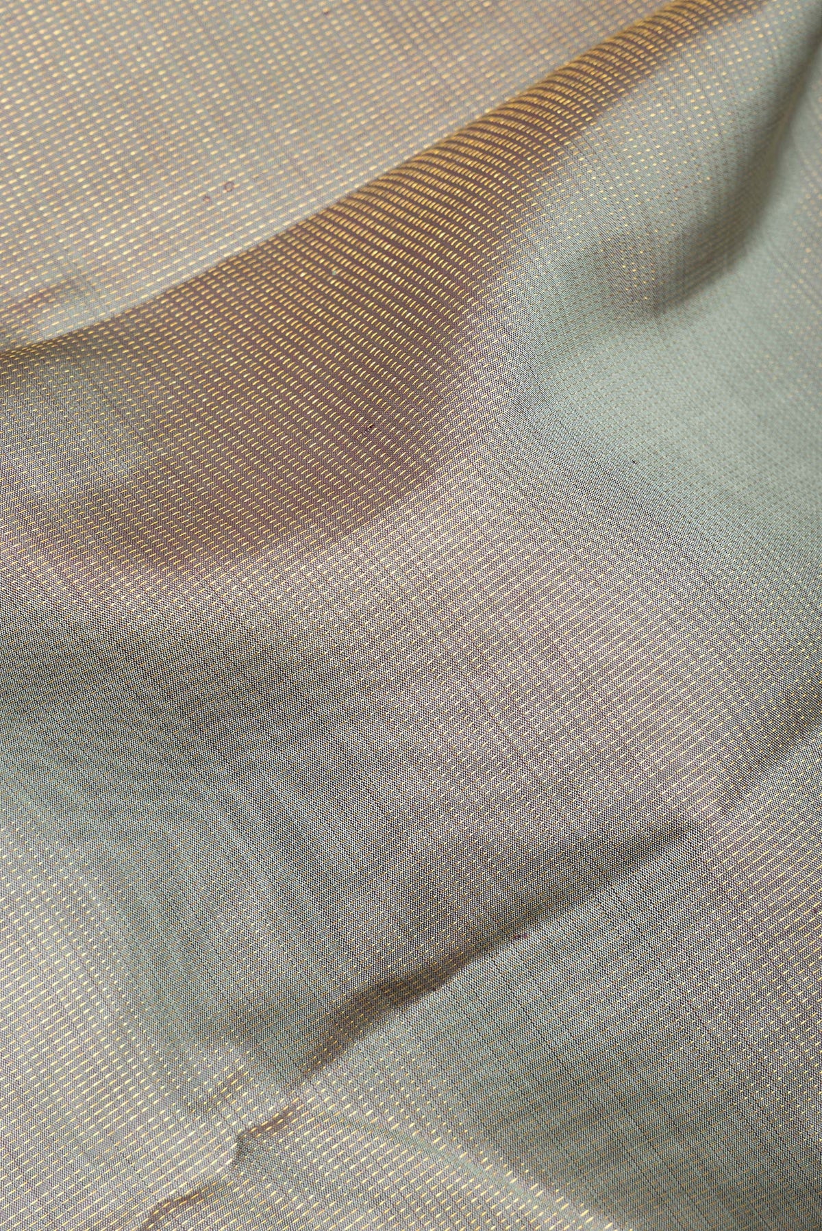 Close up of Pure Silk Grey Kanjivaram Saree with Stripes on the body and Fancy Border.  displaying folds
