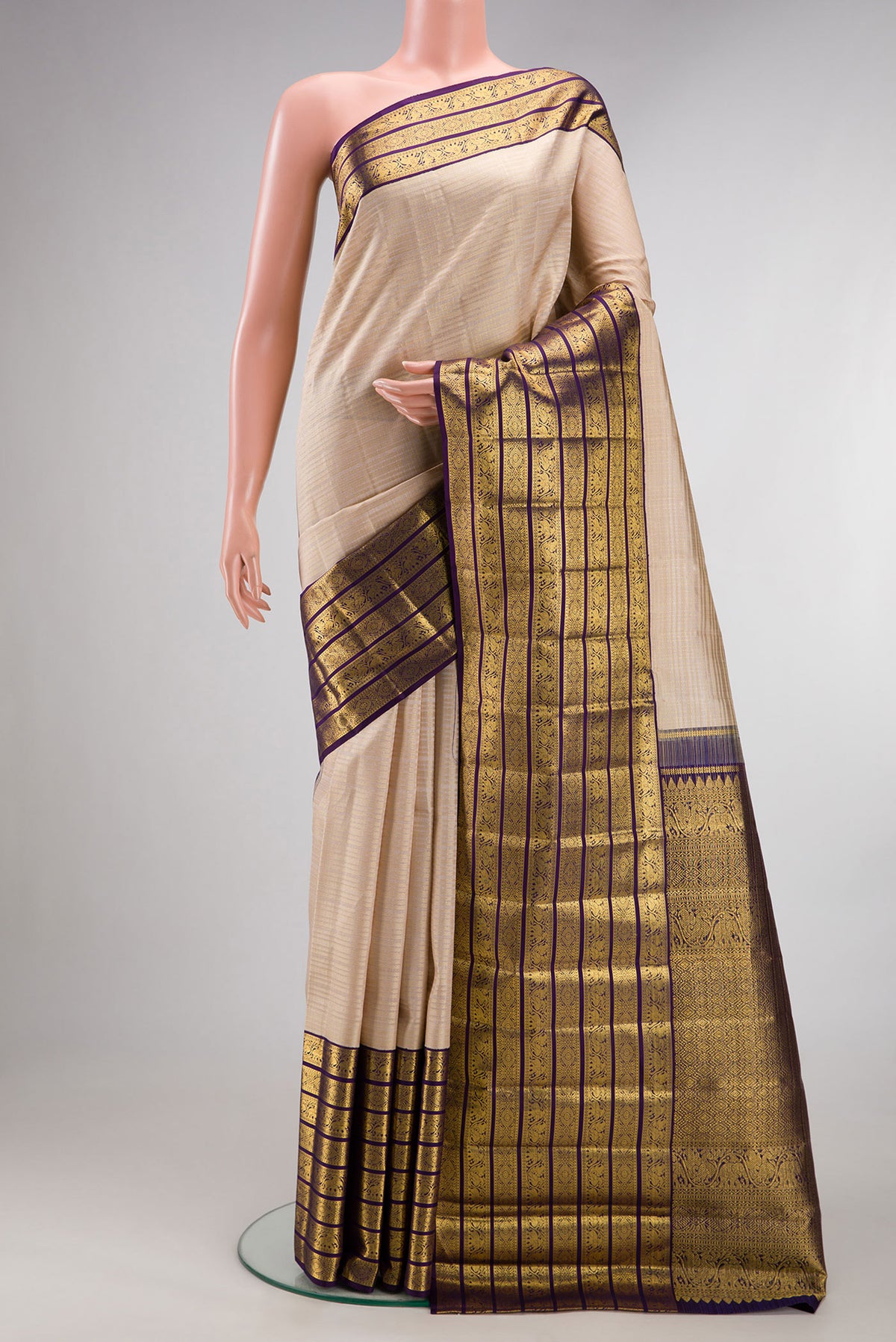 Pure Silk Beige Kanchipuram Saree with Checked design on the body and Zari Border.  displayed on a mannequin