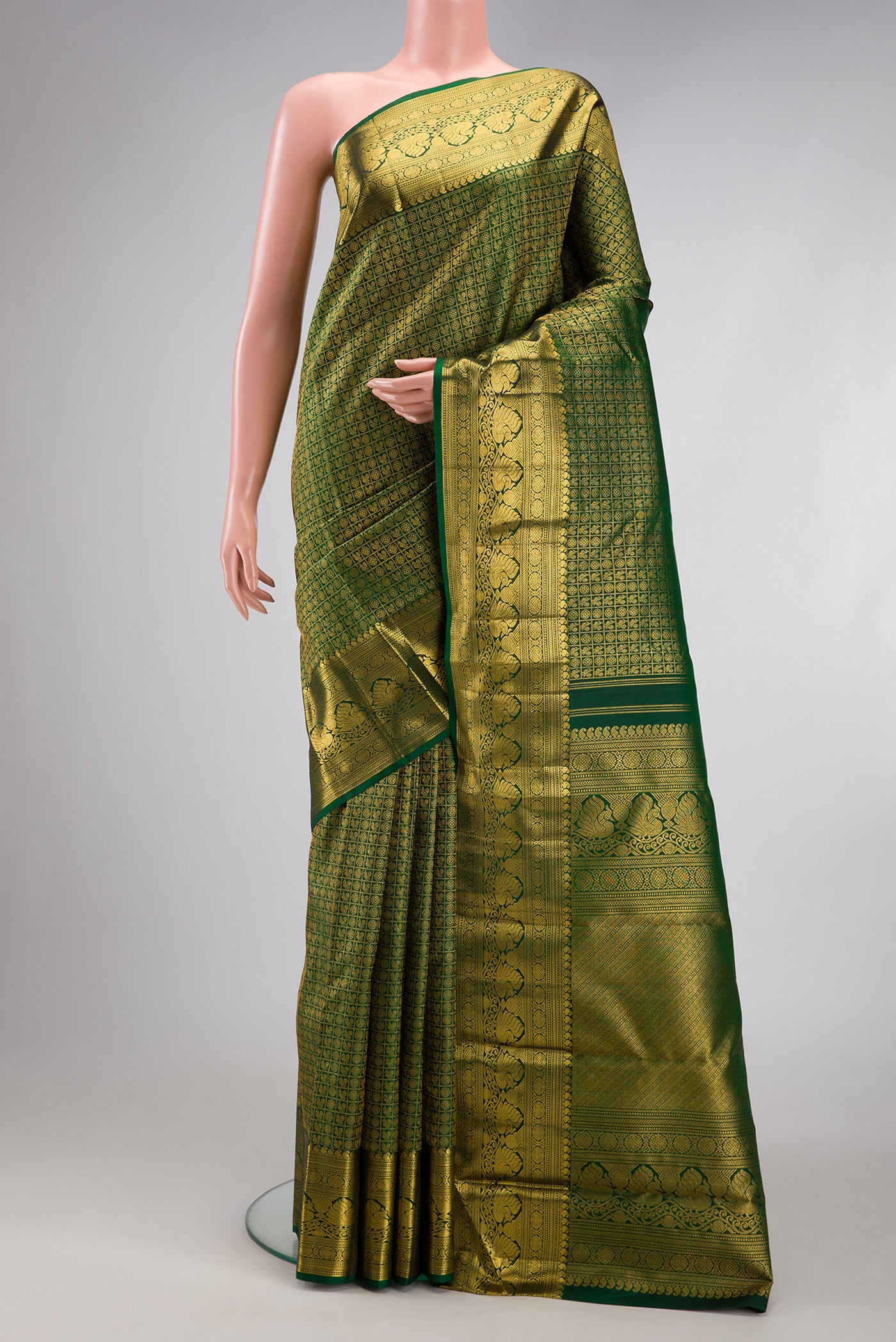 Bottle Green Kanchipuram Silk Saree with Zari Brocade on the body and Zari Border.  displayed on a mannequin