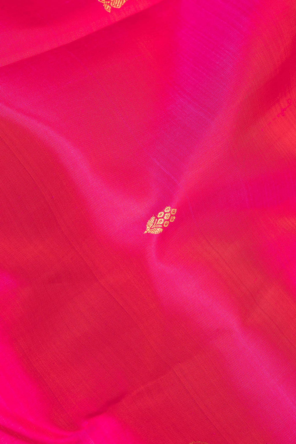 Close up of Pure Silk Pink Kanjivaram Saree with Zari Butta on the body and Fancy Border.  displaying folds
