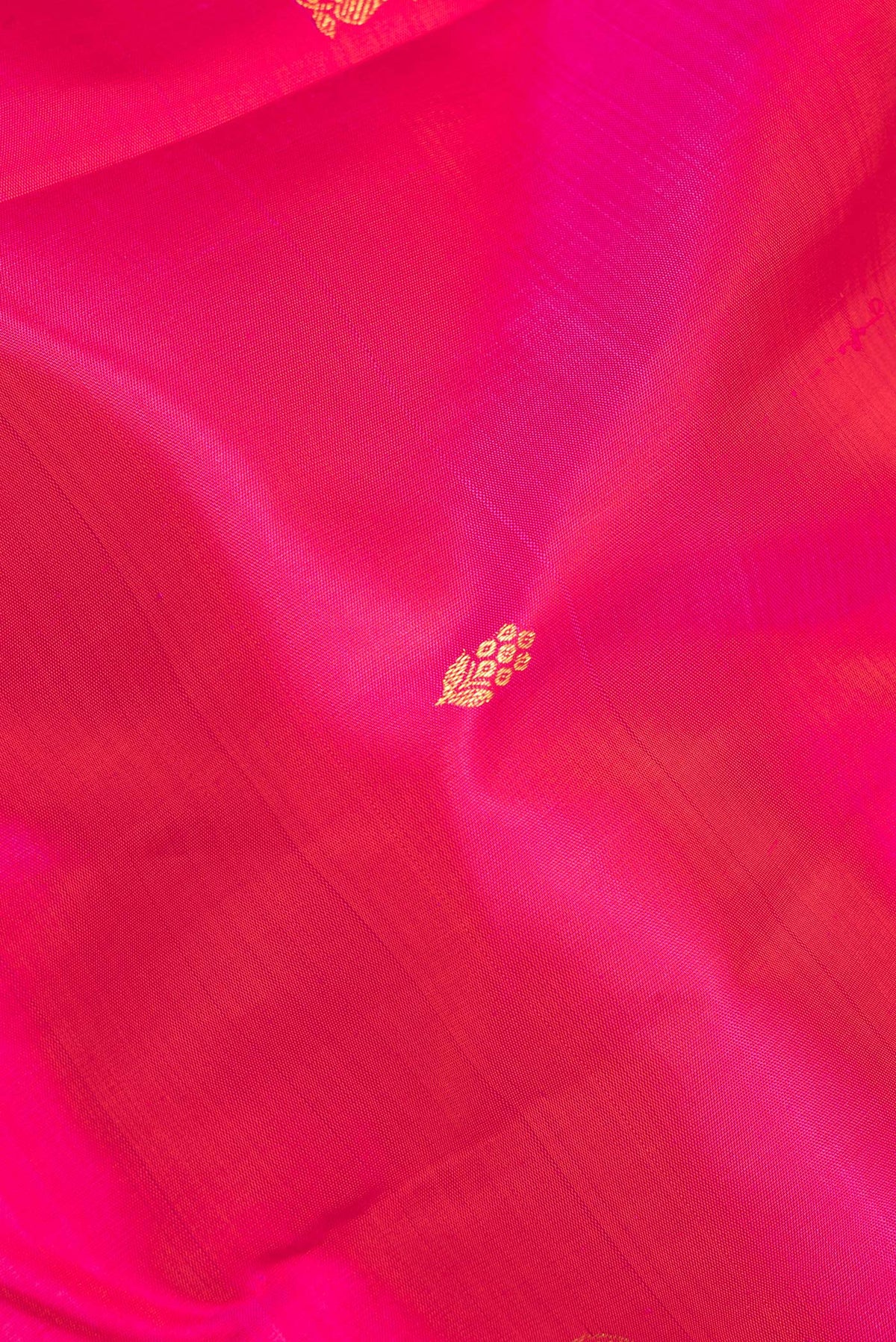 Close up of Pure Silk Pink Kanjivaram Saree with Zari Butta on the body and Fancy Border.  displaying folds