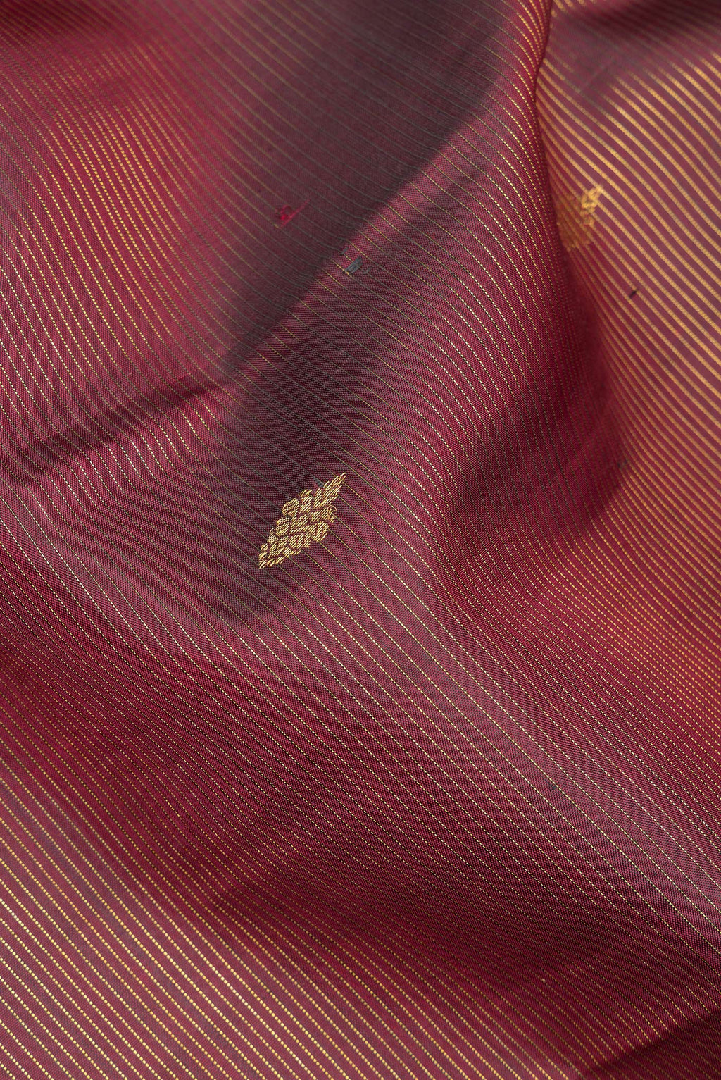 Close up of Pure Silk Maroon Kanjivaram Saree with Stripes on the body and Fancy Border.  displaying folds