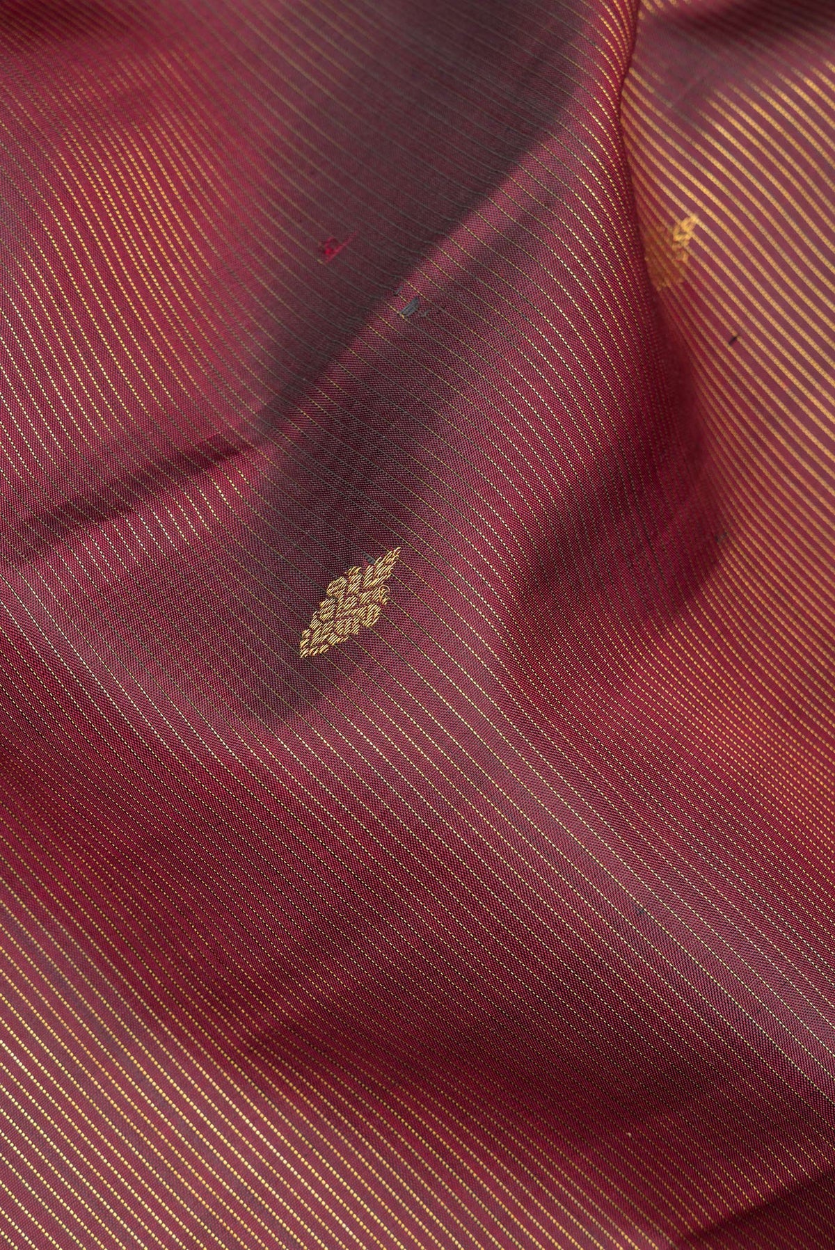 Close up of Pure Silk Maroon Kanjivaram Saree with Stripes on the body and Fancy Border.  displaying folds