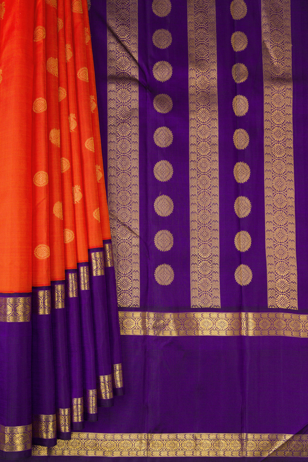 Pleats and pallu of Pure Silk Pure Zari Brick Orange Dual Tone Kanchipuram Saree with Zari Butta on the body and Zari Border. 