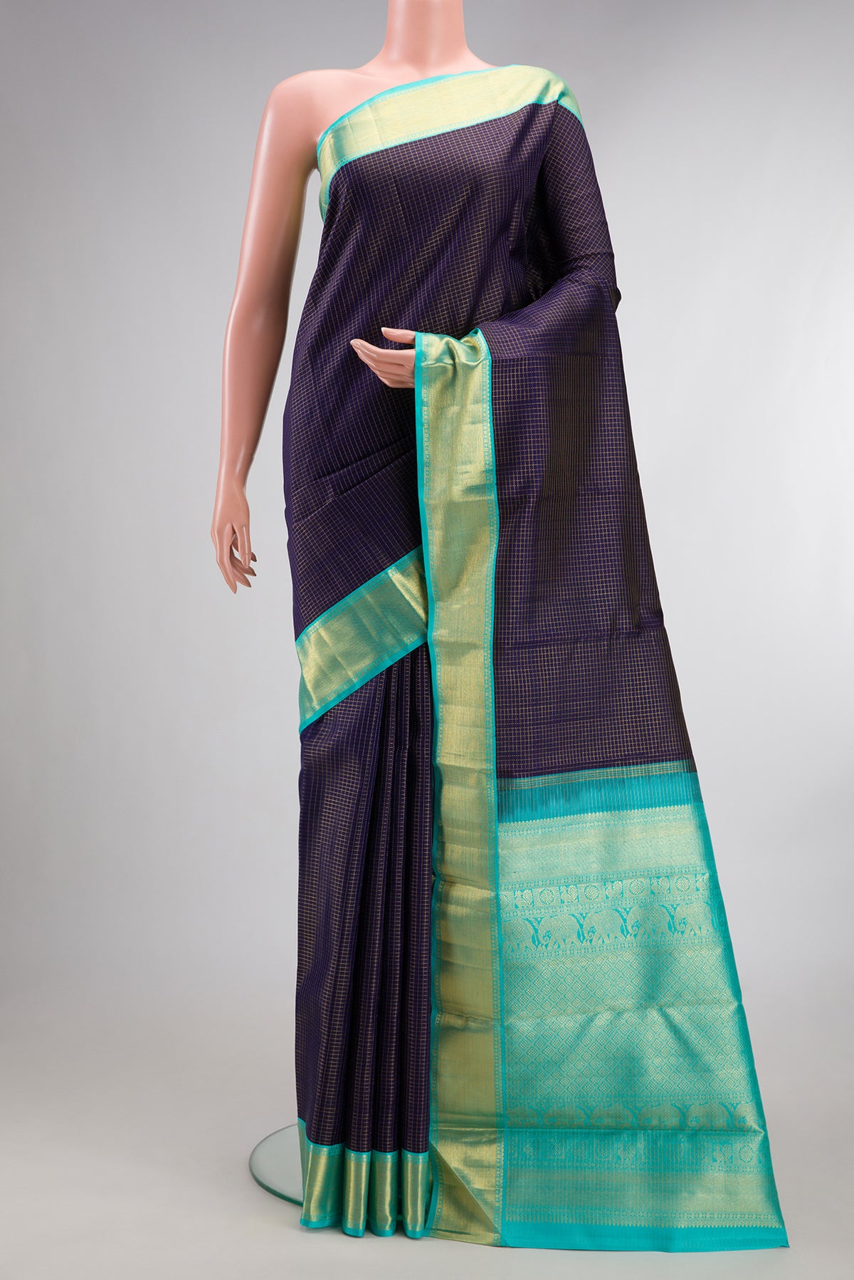 Pure Silk Navy Blue Kanchipuram Saree with Checked design on the body and Zari Border.  displayed on a mannequin