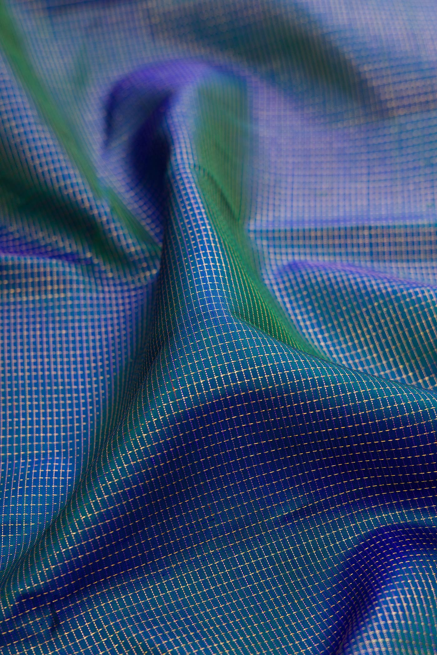 Close up of Peacock Blue Dual Tone Kanchipuram Silk Saree with Checked design on the body and Zari Border.  displaying folds