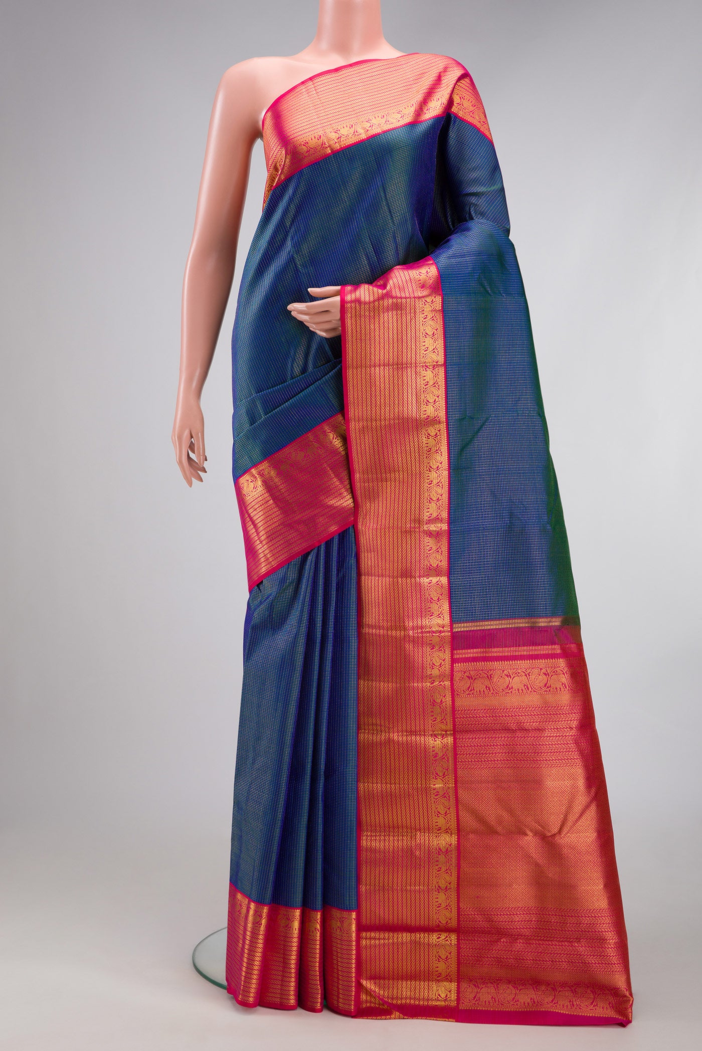 Peacock Blue Dual Tone Kanchipuram Silk Saree with Checked design on the body and Zari Border.  displayed on a mannequin