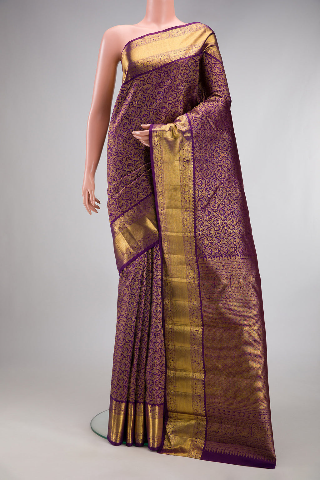 Purple Kanchipuram Silk Saree with Zari Brocade on the body and Zari Border.  displayed on a mannequin