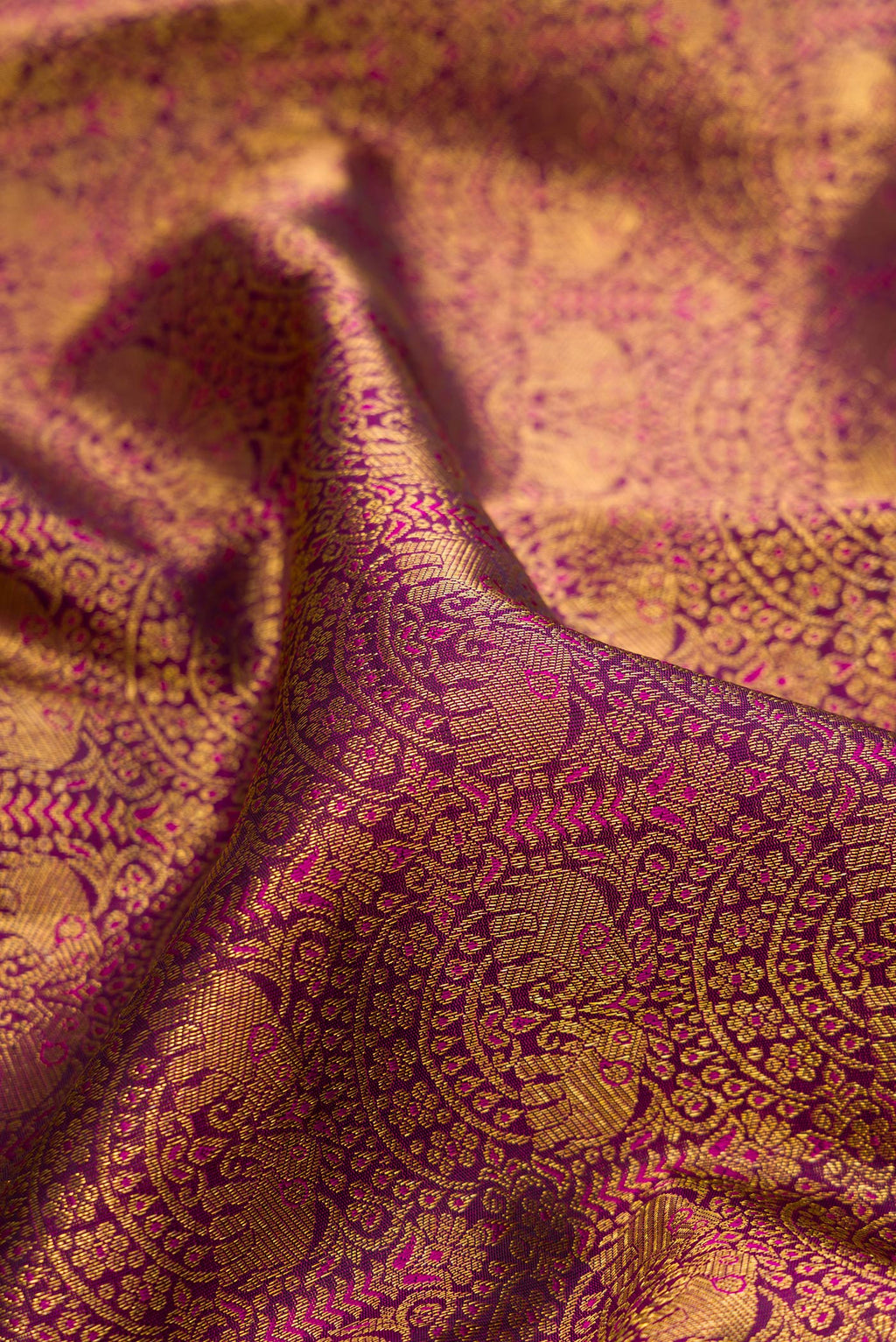 Close up of Pure Silk Purple Kanchipuram Saree with Zari Brocade on the body and Zari Border.  displaying folds