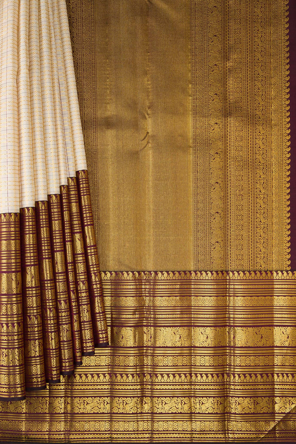 Pleats and pallu of Cream Kanchipuram Silk Saree with Checked design on the body and Zari Border. 