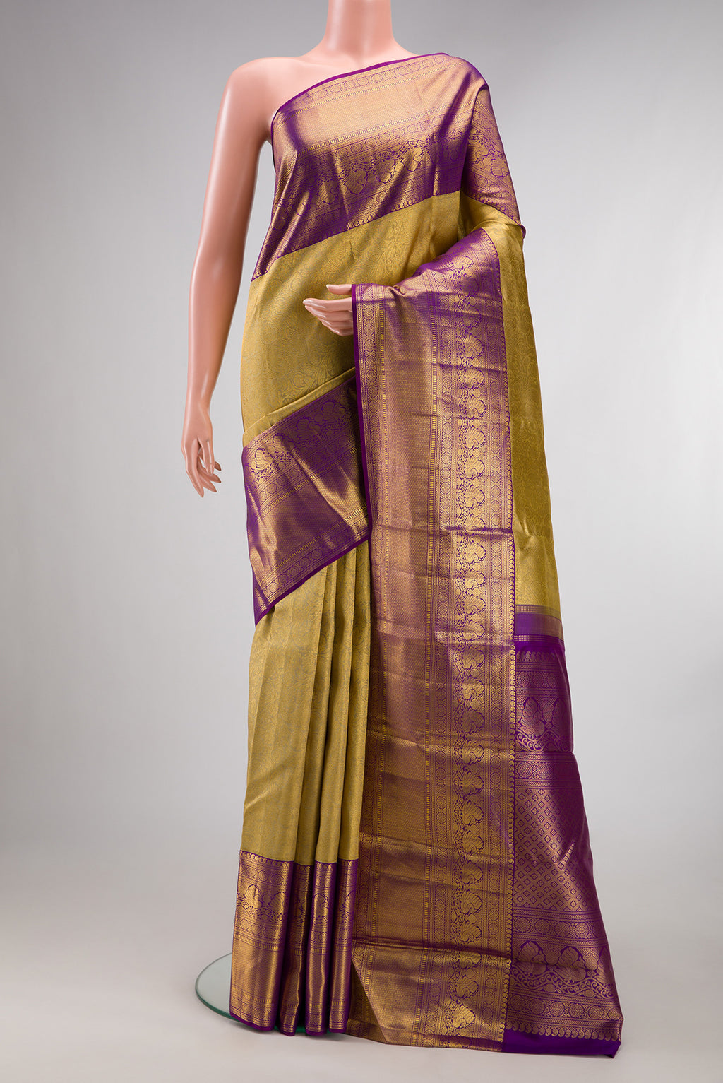 Pure Silk Gold Kanchipuram Saree with Zari Brocade on the body and Zari Border.  displayed on a mannequin