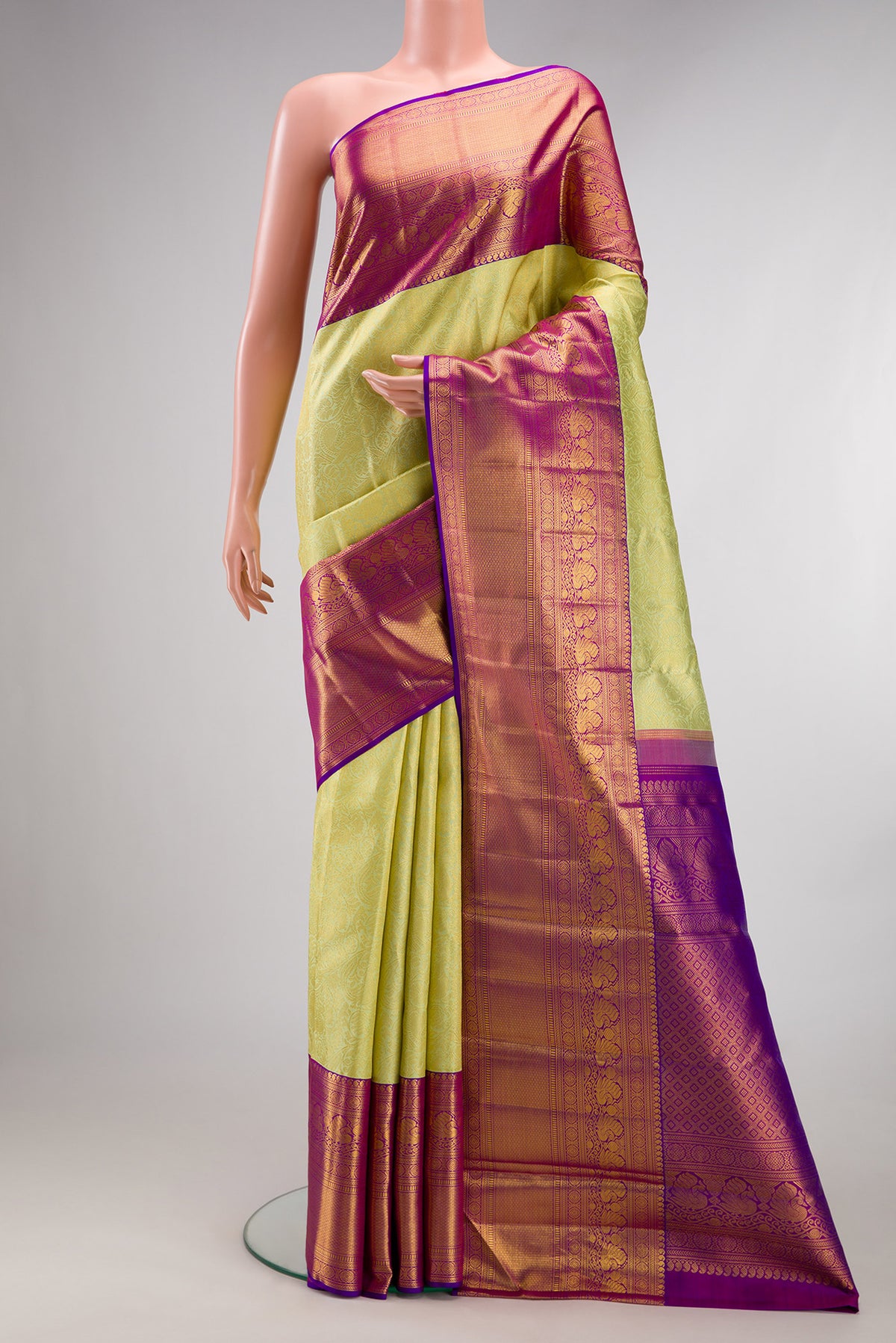 Pure Silk Pista Green Kanchipuram Saree with Zari Brocade on the body and Zari Border.  displayed on a mannequin