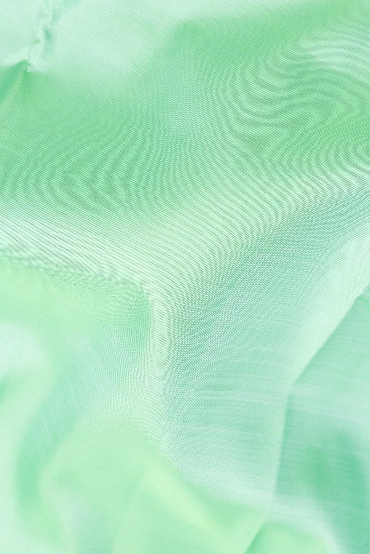 Close up of Pure Silk Sea Green Kanjivaram Saree with Plain Body and Zari Border.  displaying folds