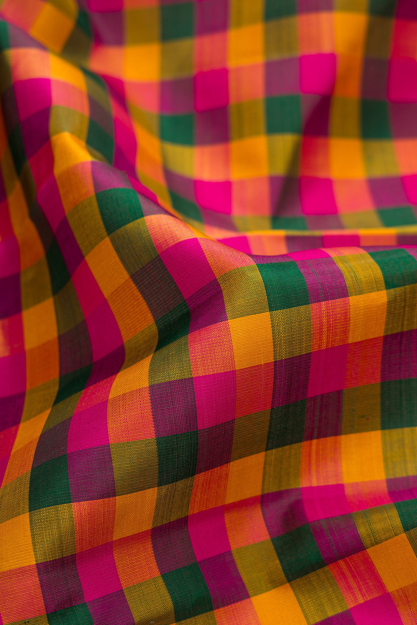 Close up of Multi Color Kanchipuram Silk Saree with Checked design on the body and Zari Border.  displaying folds