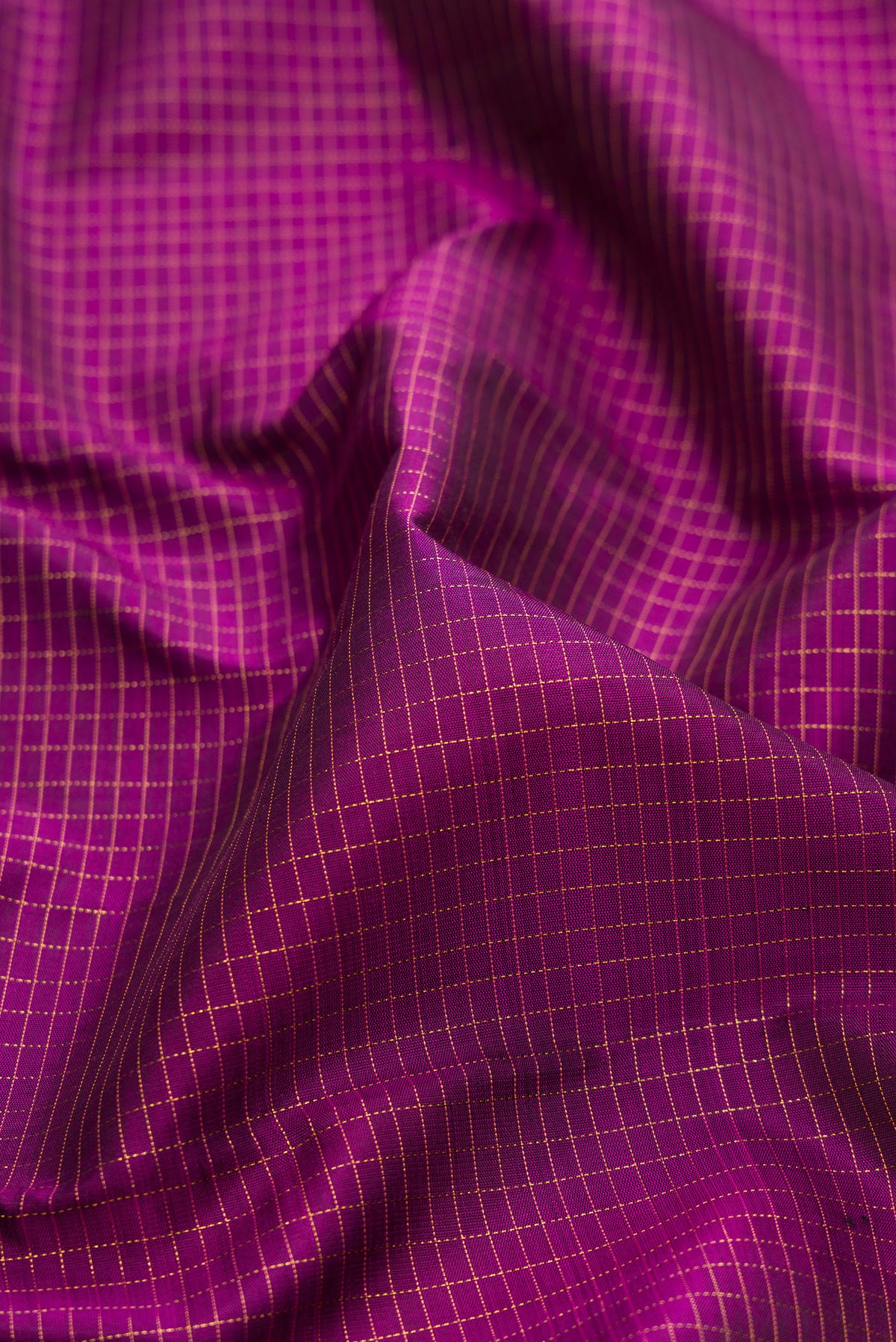 Close up of Pure Silk Purple Kanchipuram Saree with Checked design on the body and Zari Border.  displaying folds