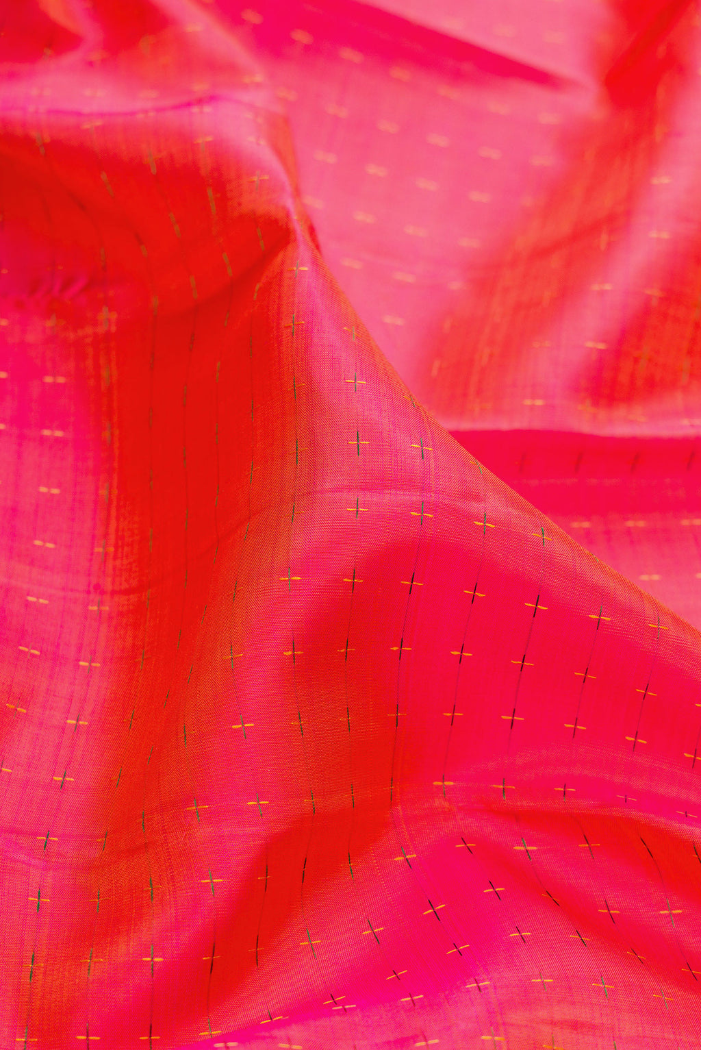 Close up of Pure Silk PInk with Orange Color Kanjivaram Saree with Checked design on the body and Zari Border.  displaying folds