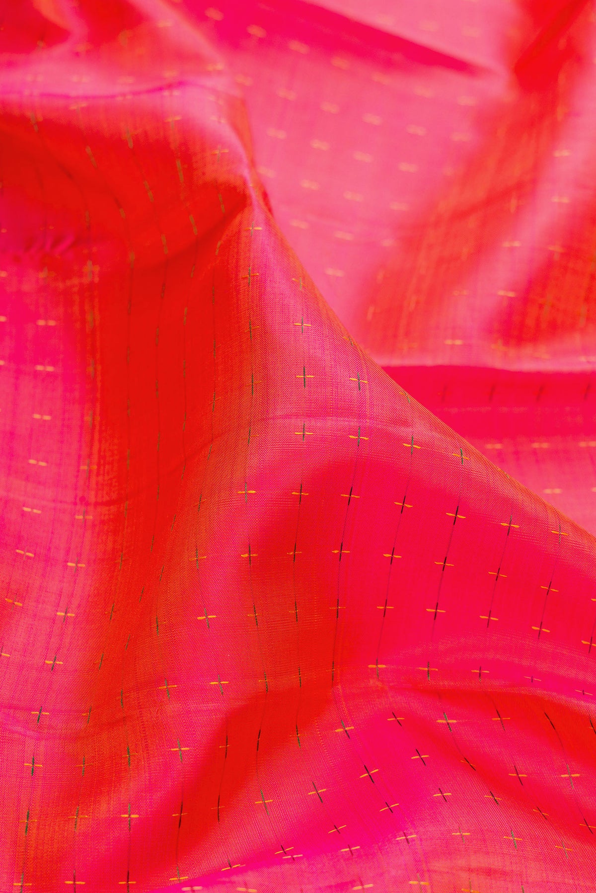 Close up of Pure Silk PInk with Orange Color Kanjivaram Saree with Checked design on the body and Zari Border.  displaying folds