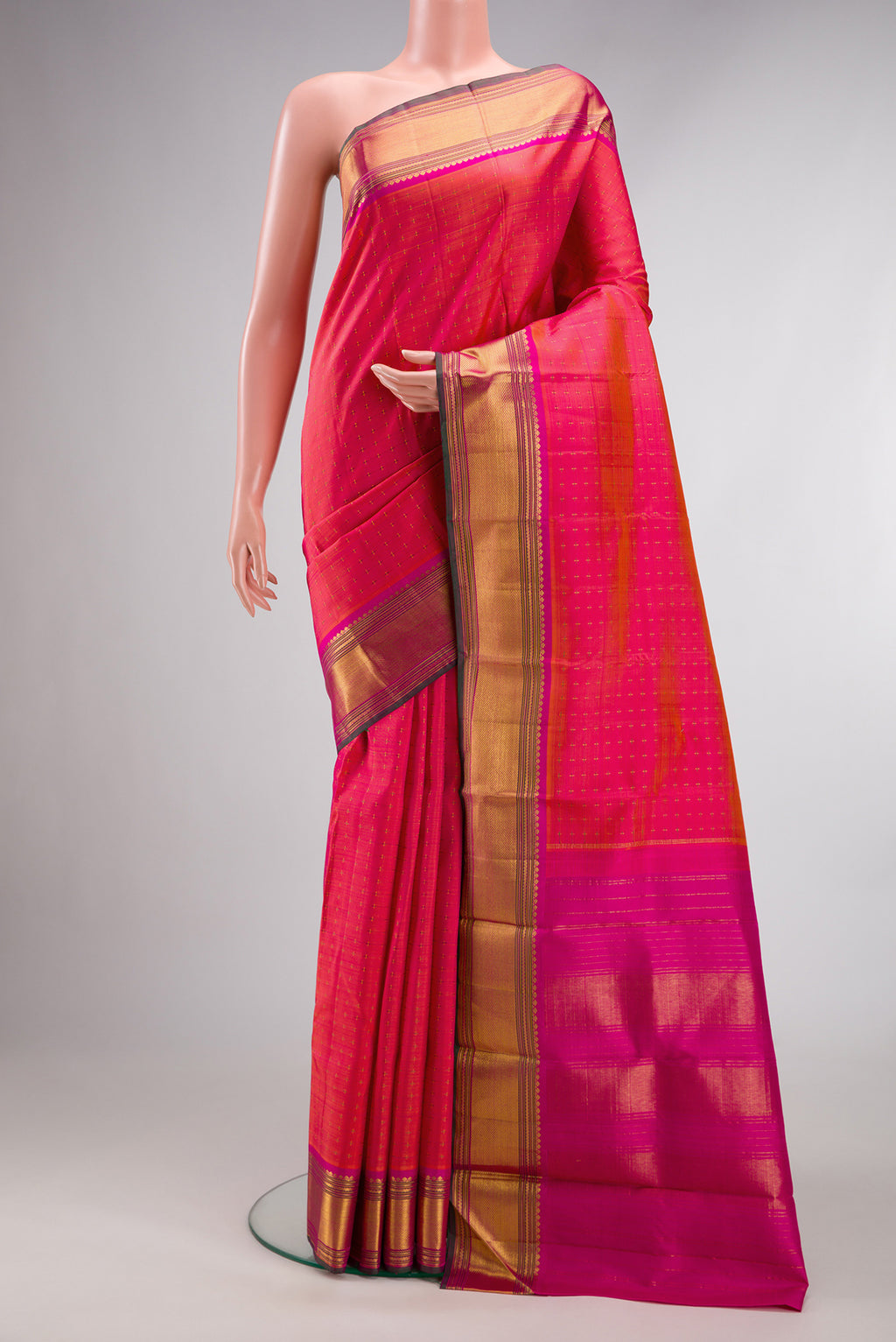 Pure Silk PInk with Orange Color Kanjivaram Saree with Checked design on the body and Zari Border.  displayed on a mannequin
