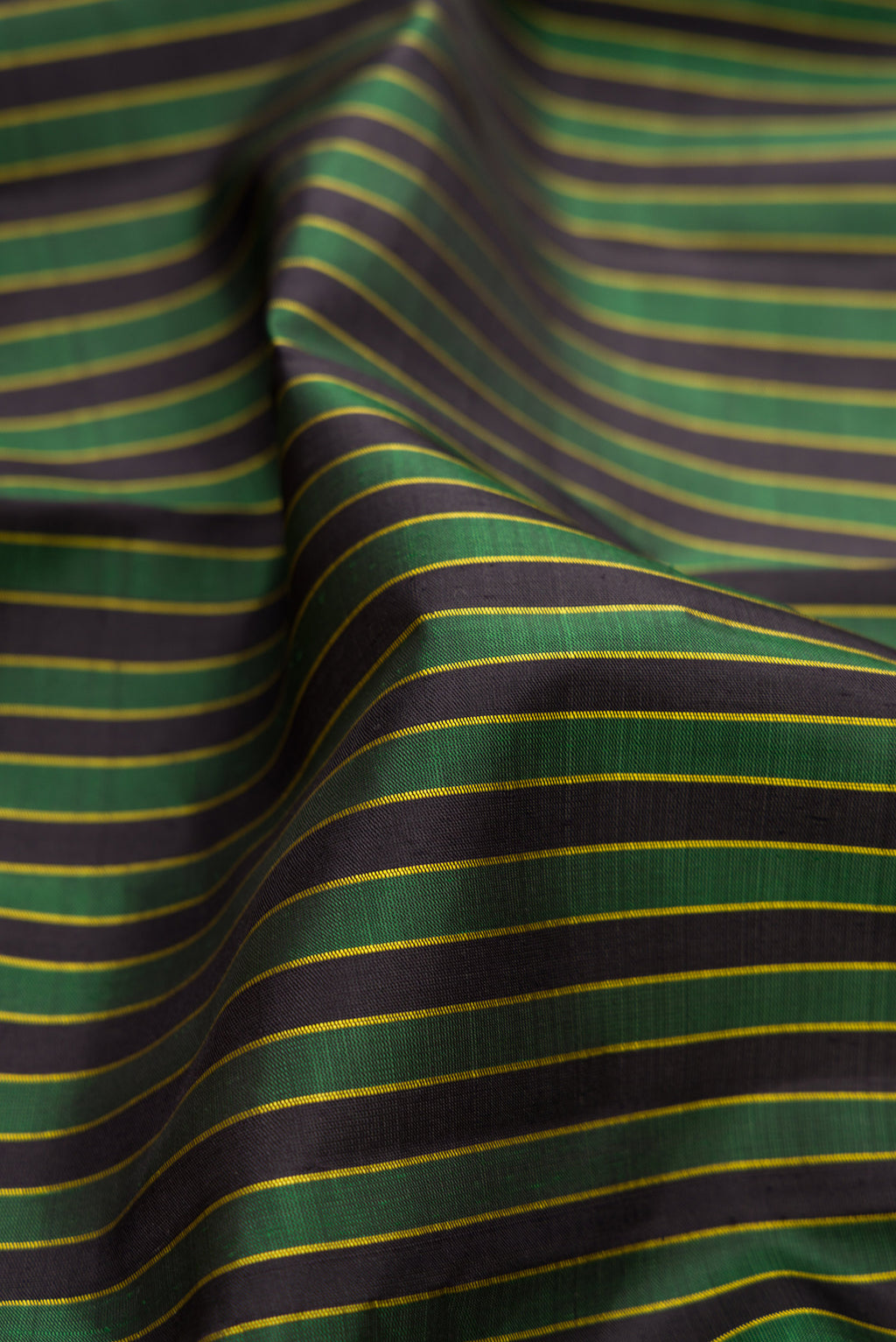 Close up of Multi Color Kanjivaram Silk Saree with Stripes on the body and Thread Border.  displaying folds