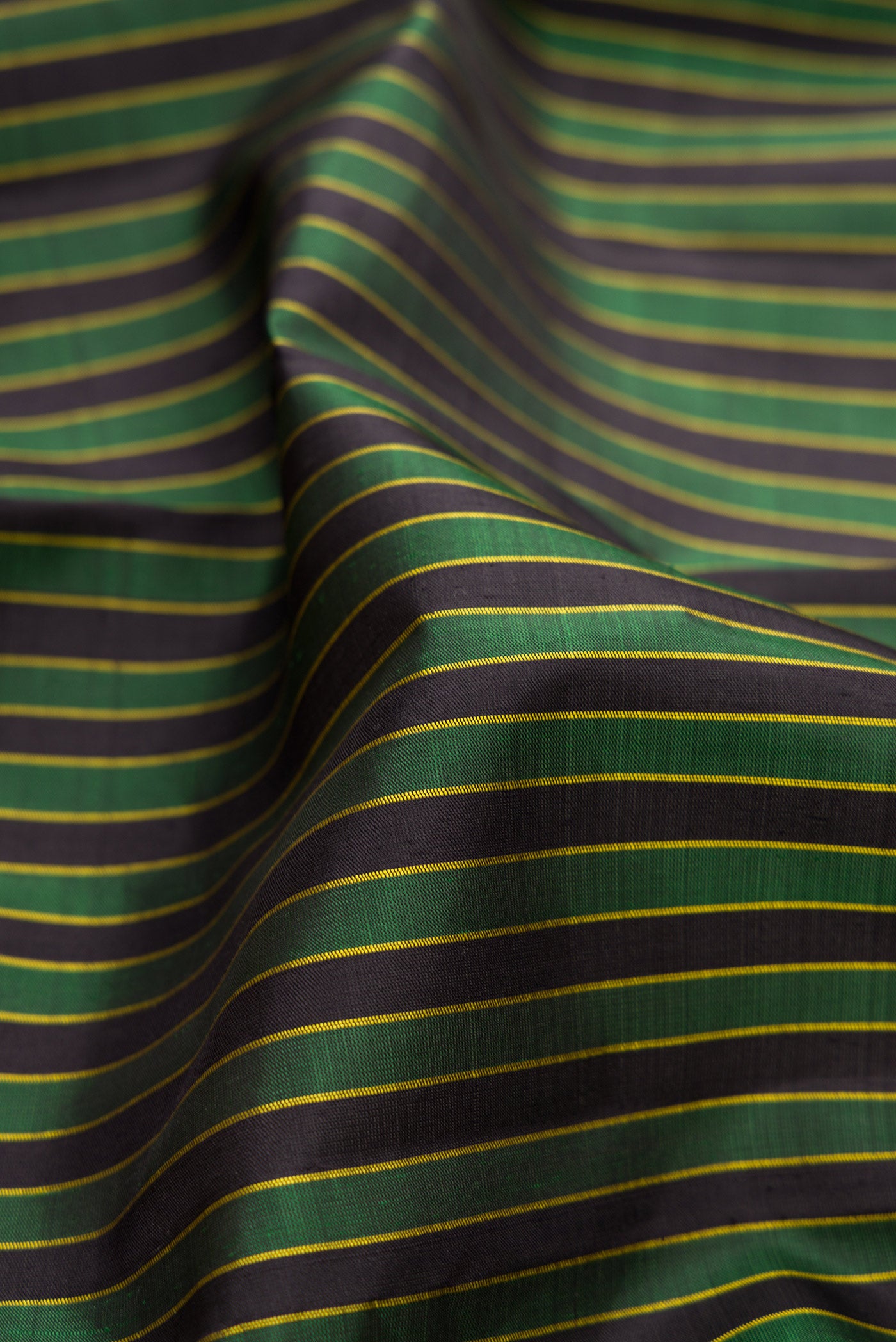 Close up of Multi Color Kanjivaram Silk Saree with Stripes on the body and Thread Border.  displaying folds