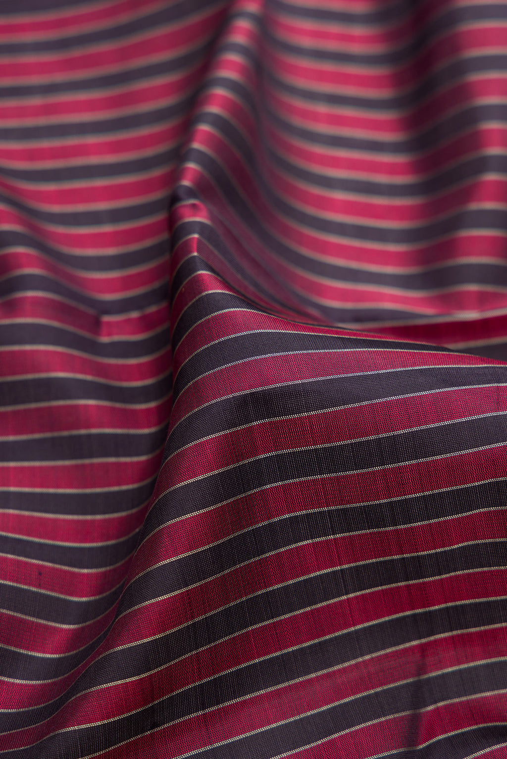 Close up of Multi Color Kanjivaram Silk Saree with Stripes on the body and Thread Border.  displaying folds