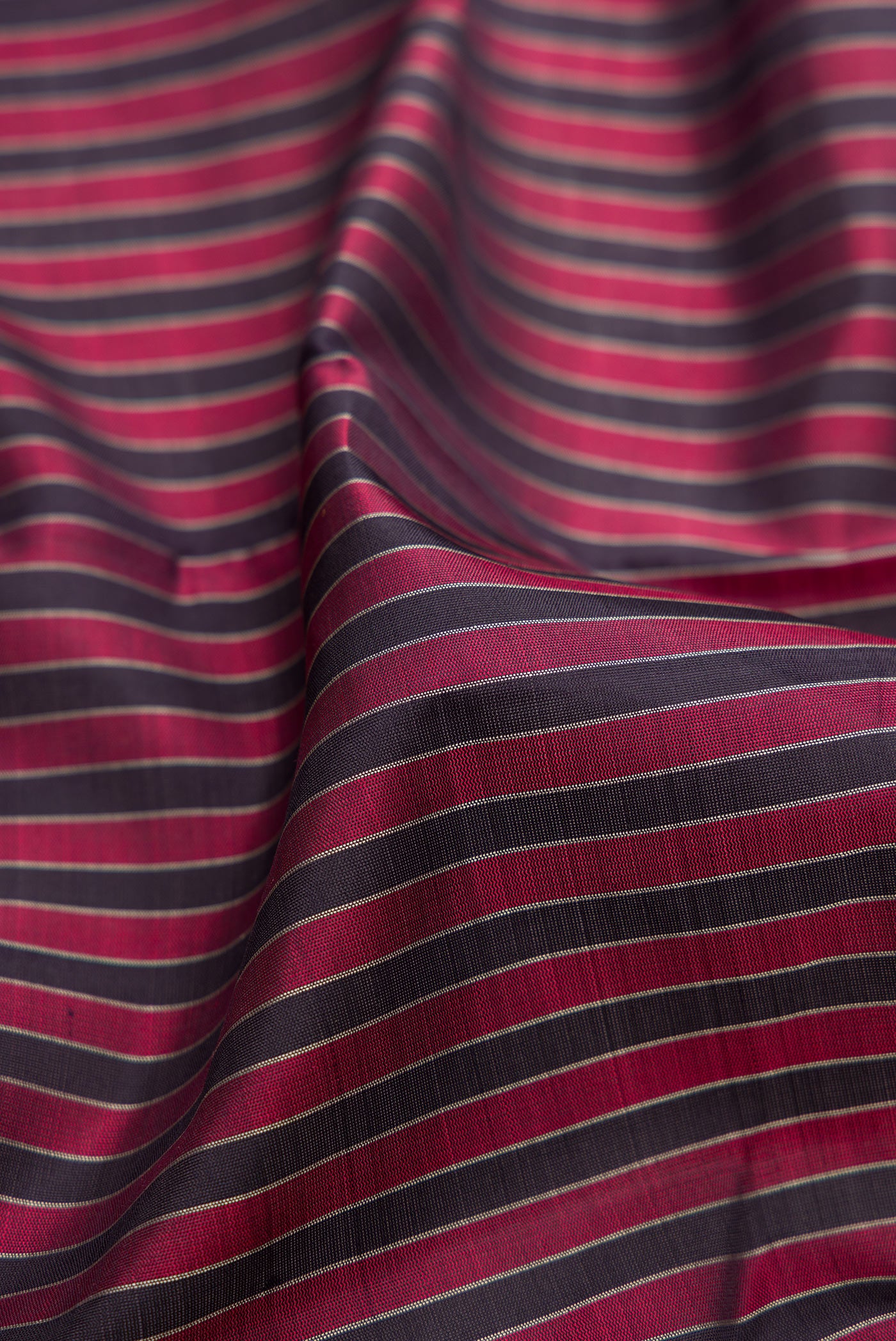 Close up of Multi Color Kanjivaram Silk Saree with Stripes on the body and Thread Border.  displaying folds