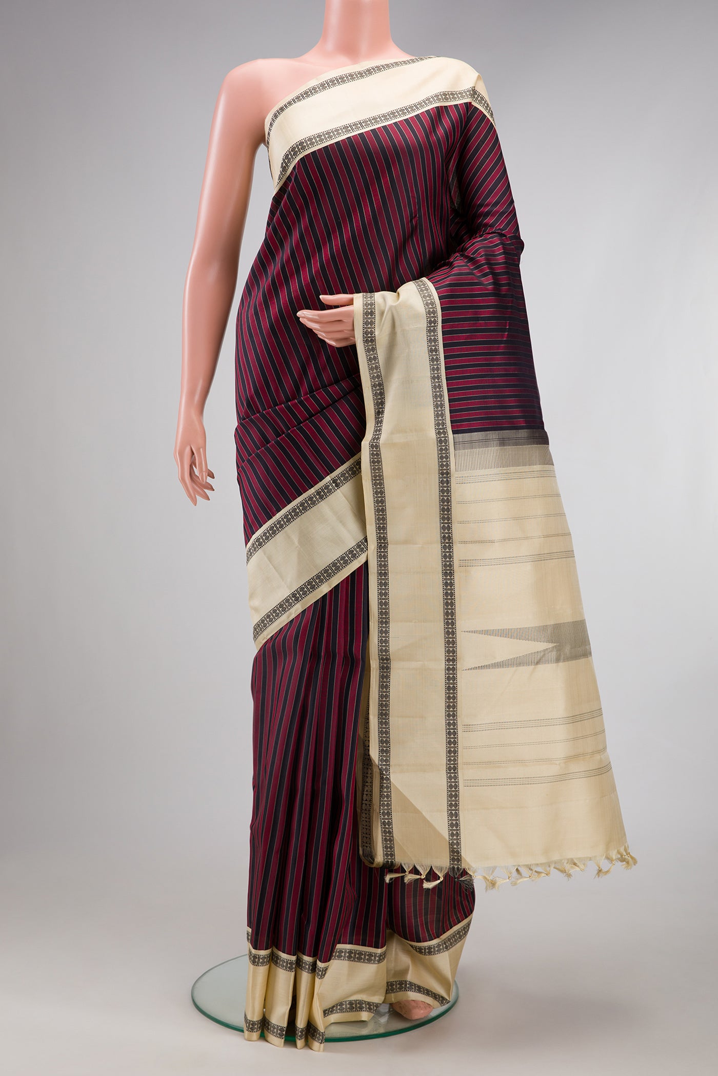 Multi Color Kanjivaram Silk Saree with Stripes on the body and Thread Border.  displayed on a mannequin