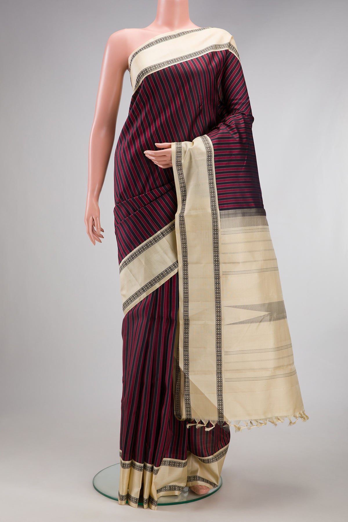 Multi Color Kanjivaram Silk Saree with Stripes on the body and Thread Border.  displayed on a mannequin
