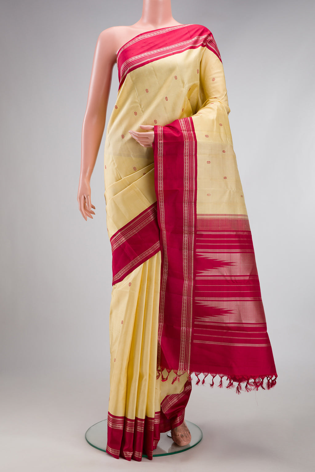 Sandal Kanjivaram Silk Saree with Thread Butta on the body and Thread Border.  displayed on a mannequin