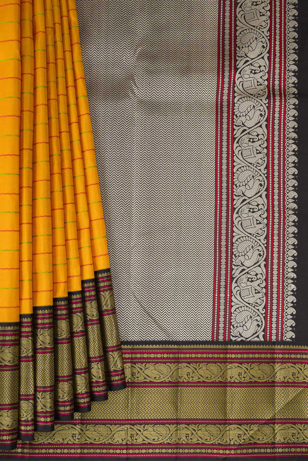 Pleats and pallu of Mustard Kanjivaram Silk Saree with Veldhari on the body and Thread Border. 
