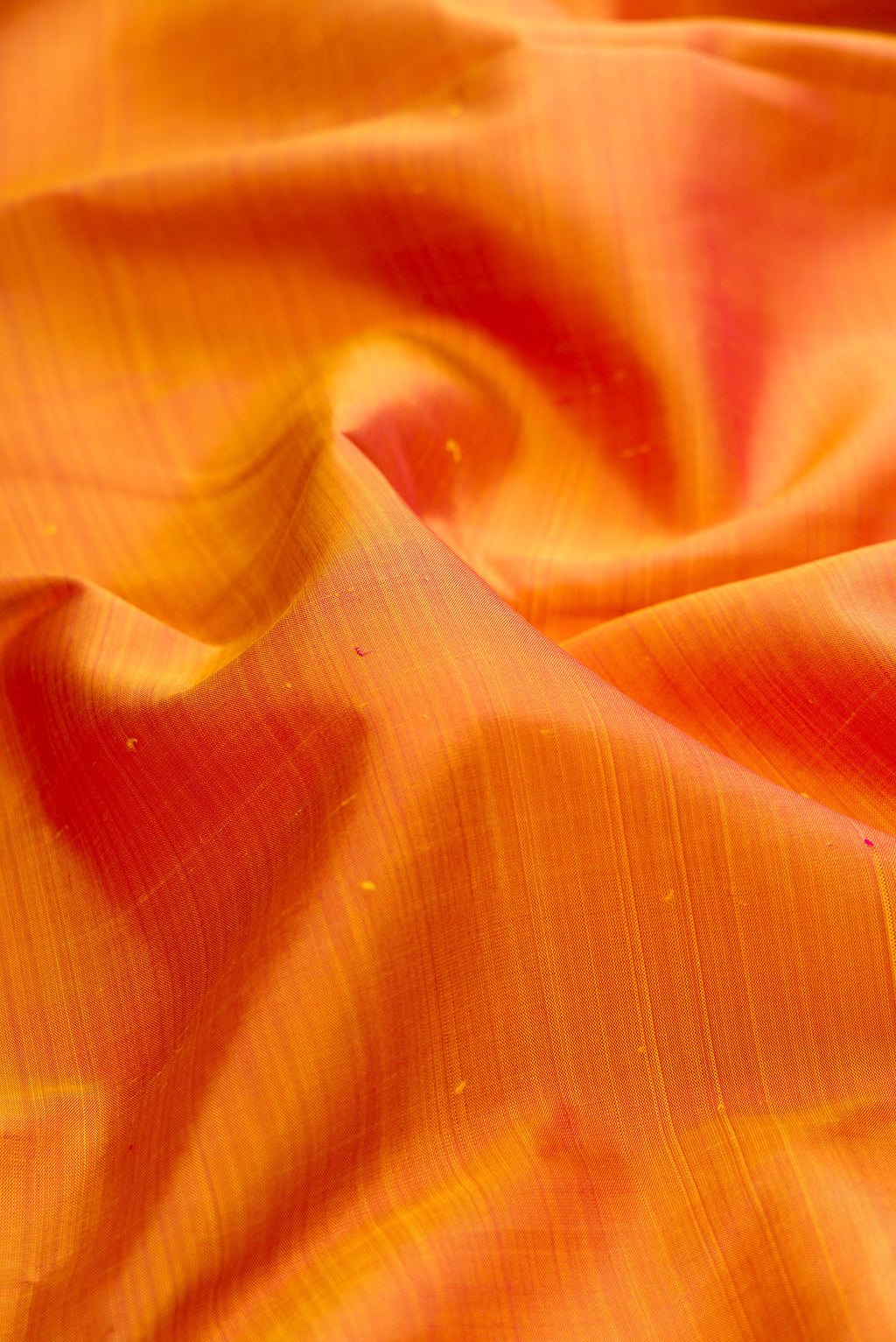 Close up of Pure Silk Mustard Dual Tone Kanchipuram Saree with Plain Body and Temple Border.  displaying folds