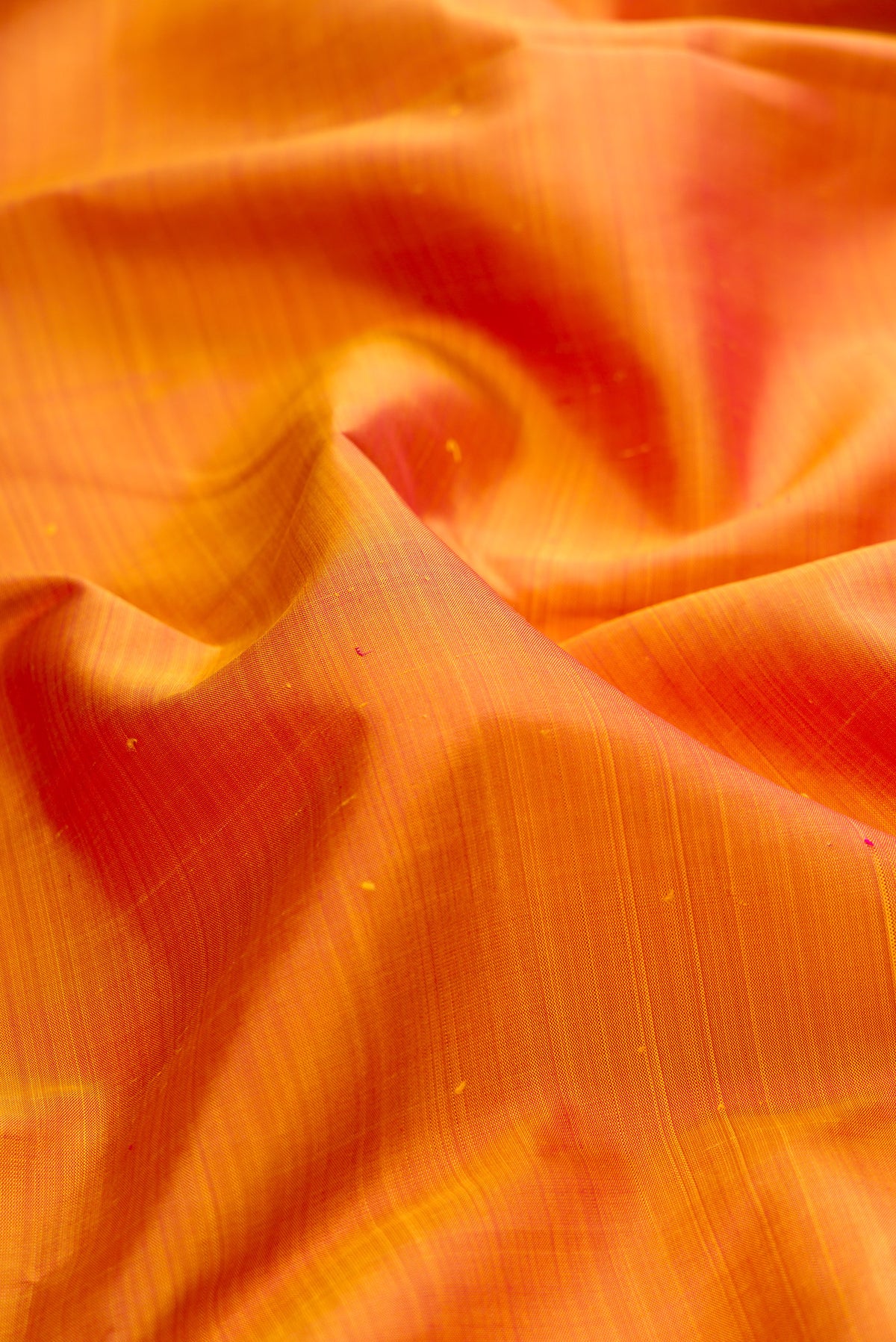 Close up of Pure Silk Mustard Dual Tone Kanchipuram Saree with Plain Body and Temple Border.  displaying folds