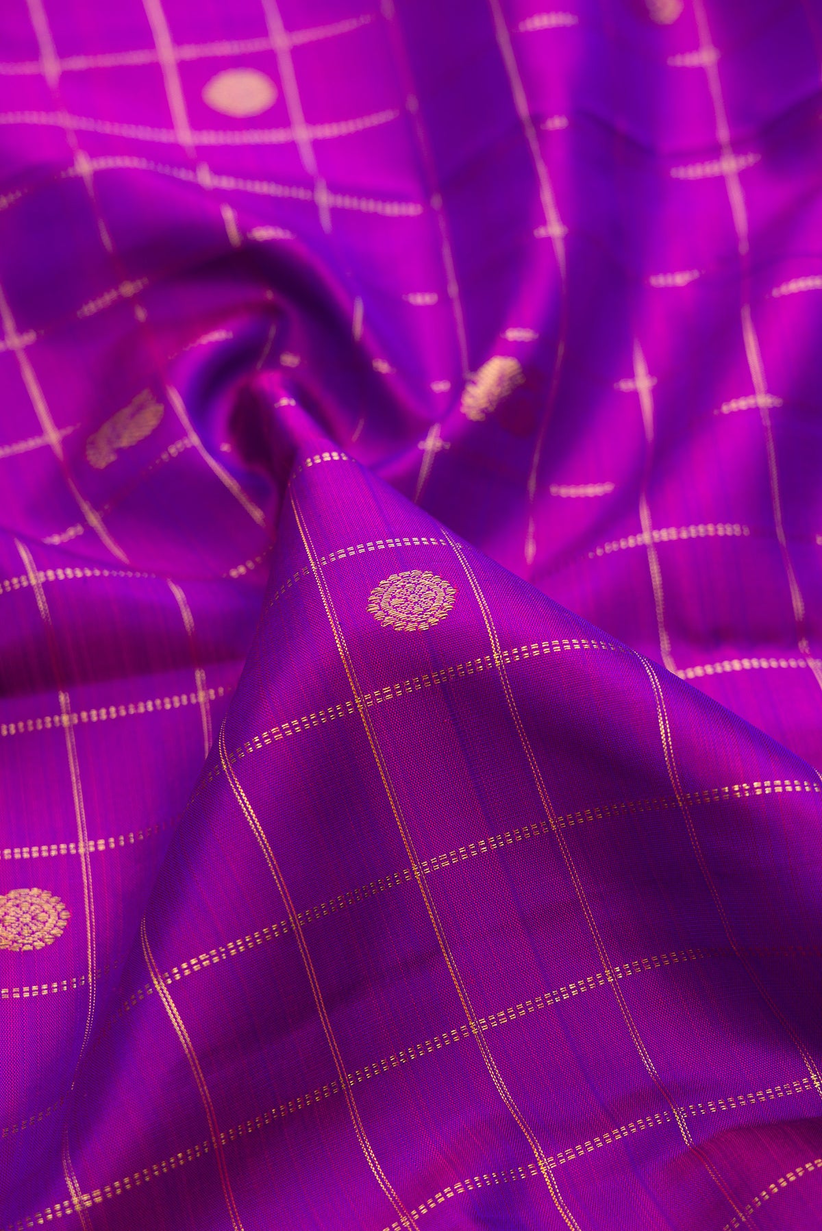 Close up of Pure Silk Purple Dual Tone Kanjivaram Saree with Checked design on the body and Zari Border.  displaying folds
