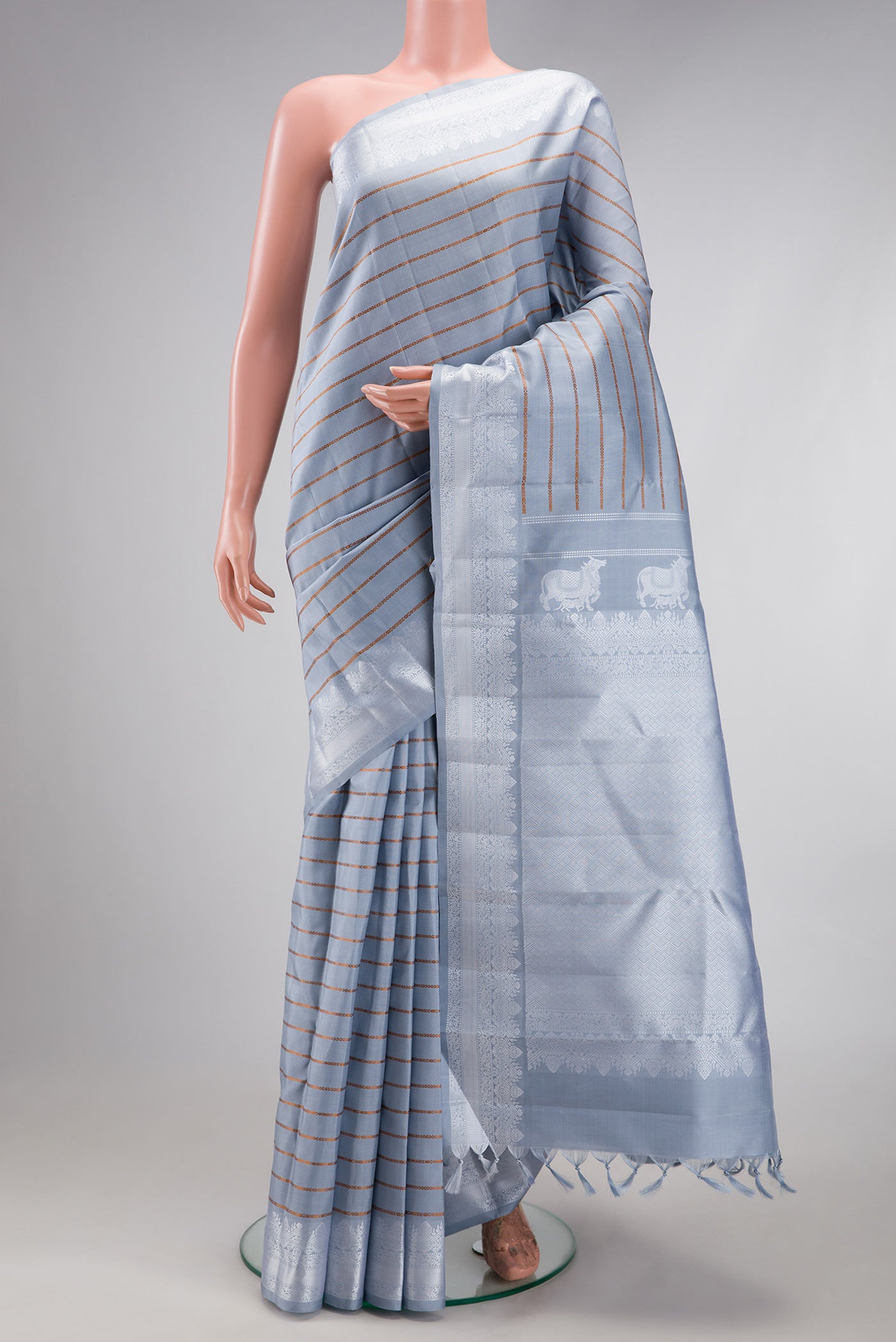 Lilac Kanjivaram Silk Saree with Veldhari on the body and Thread Border.  displayed on a mannequin