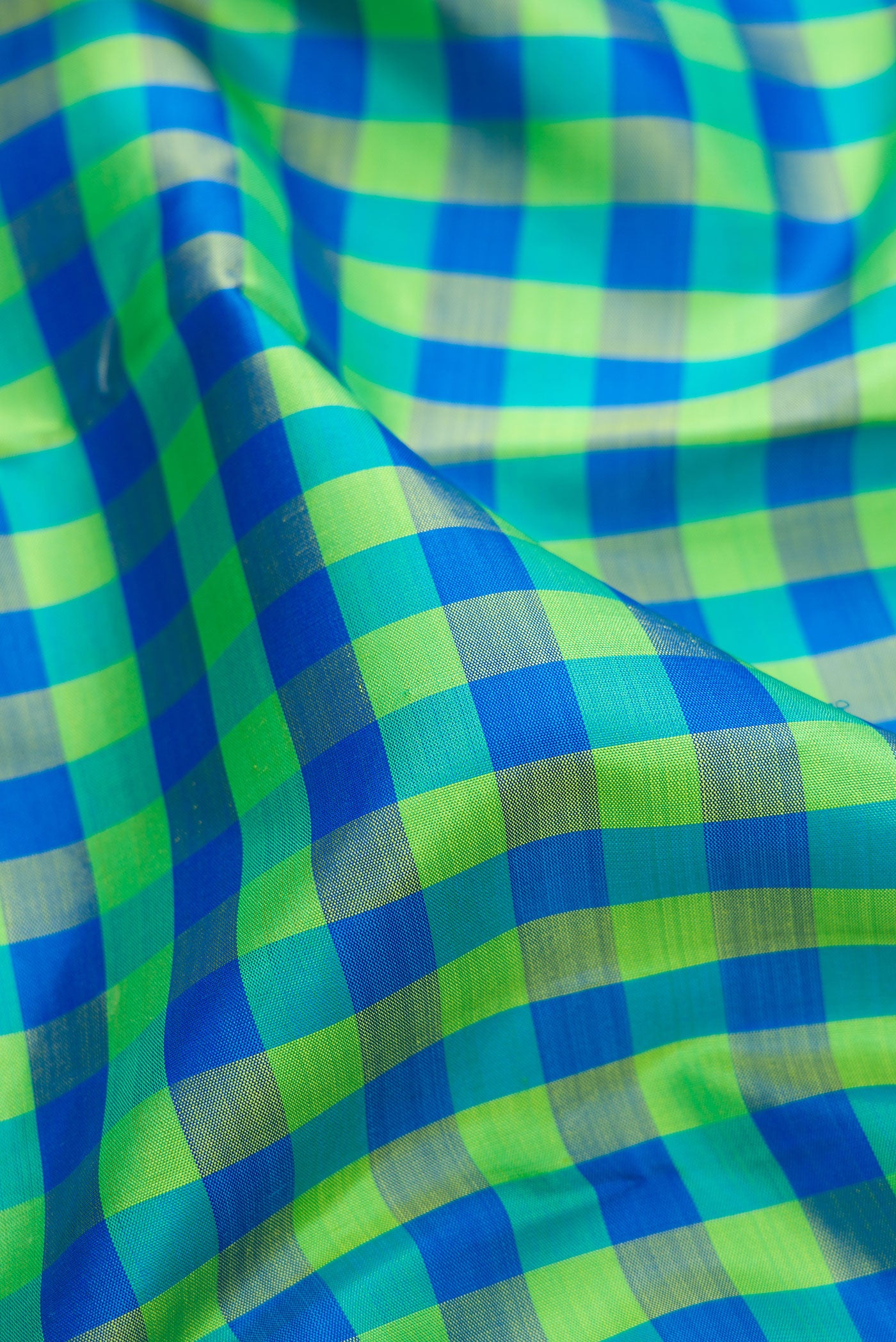 Close up of Multi Color Kanjivaram Silk Saree with Checked design on the body and Zari Border.  displaying folds