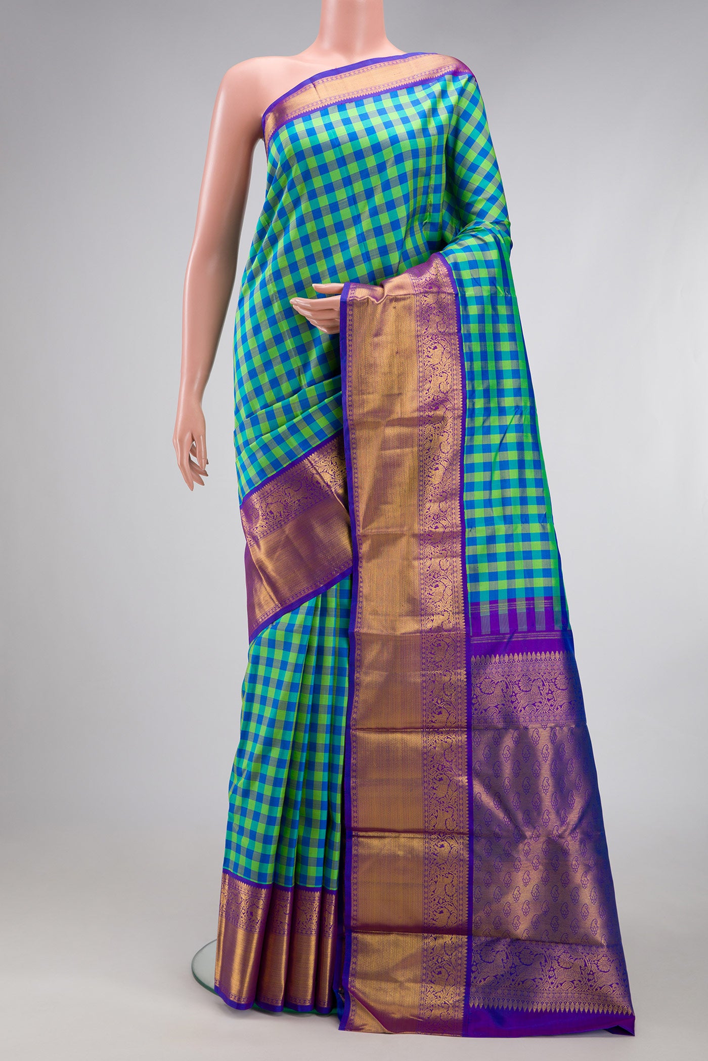 Multi Color Kanjivaram Silk Saree with Checked design on the body and Zari Border.  displayed on a mannequin