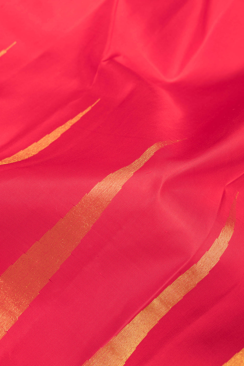 Close up of Pure Silk Red Dual Tone Kanjivaram Saree with Stripes on the body and Fancy Border.  displaying folds