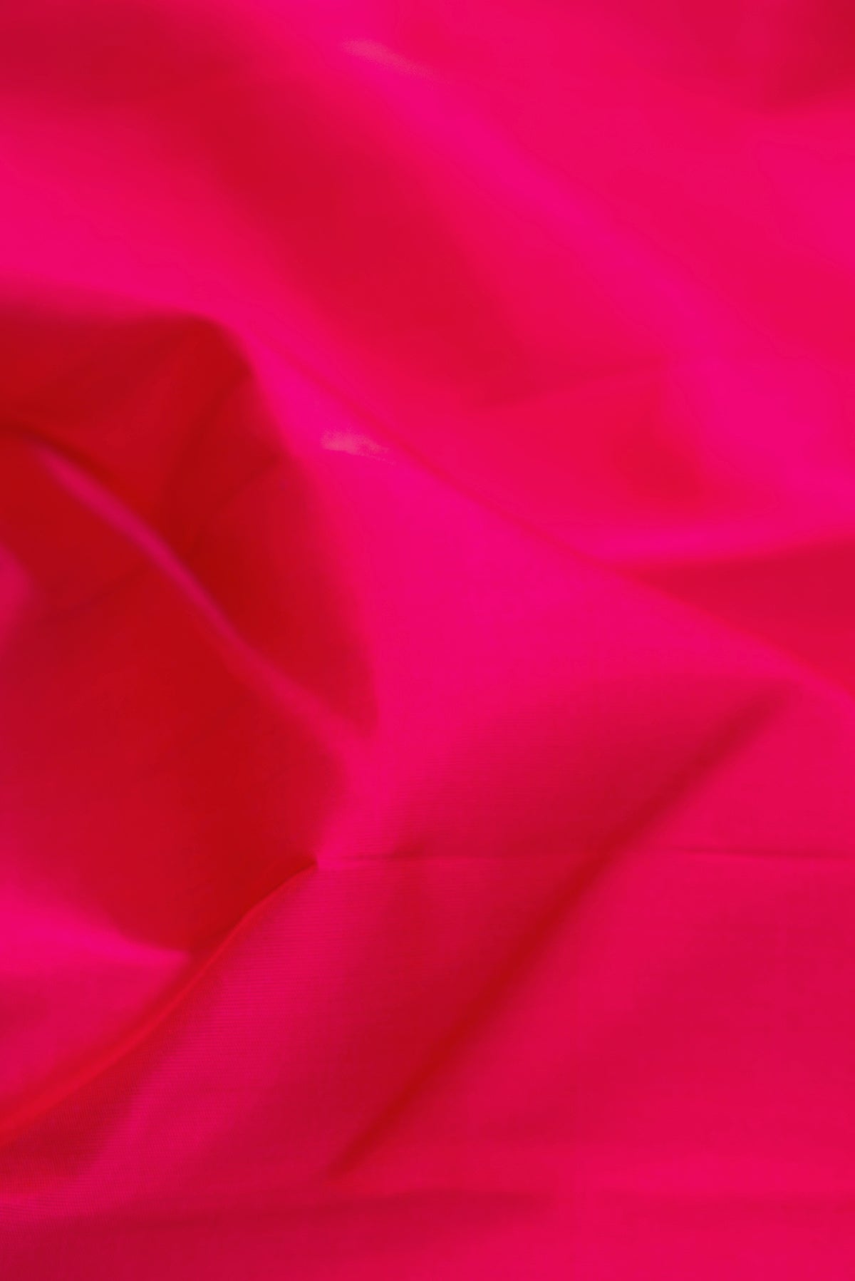 Close up of Pure Silk Pure Zari Pink Kanchipuram Saree with Plain Body and Temple Border.  displaying folds