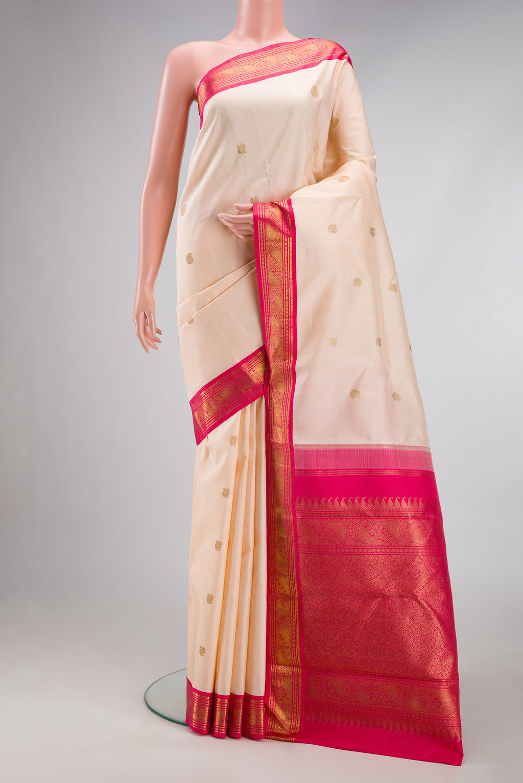 Pure Silk Pure Zari Cream Dual Tone Kanjivaram Saree with Zari Butta on the body and Zari Border.  displayed on a mannequin