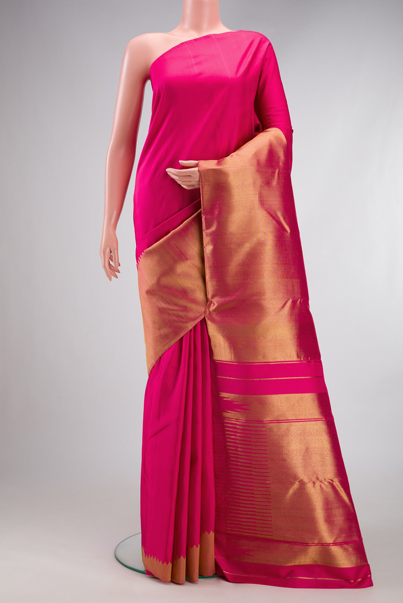 Pure Silk Pure Zari Pink Kanjivaram Saree with Plain Body and Rising Temple Border.  displayed on a mannequin
