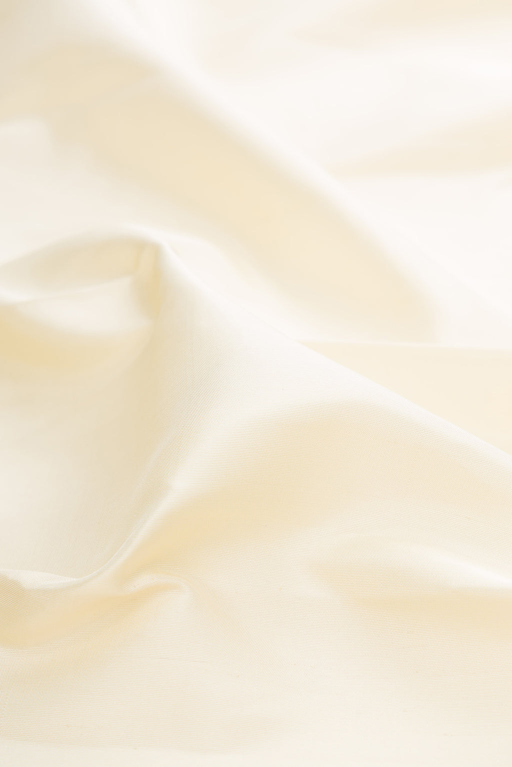 Close up of Pure Silk Pure Zari Off White Kanjivaram Saree with Plain Body and Temple Border.  displaying folds