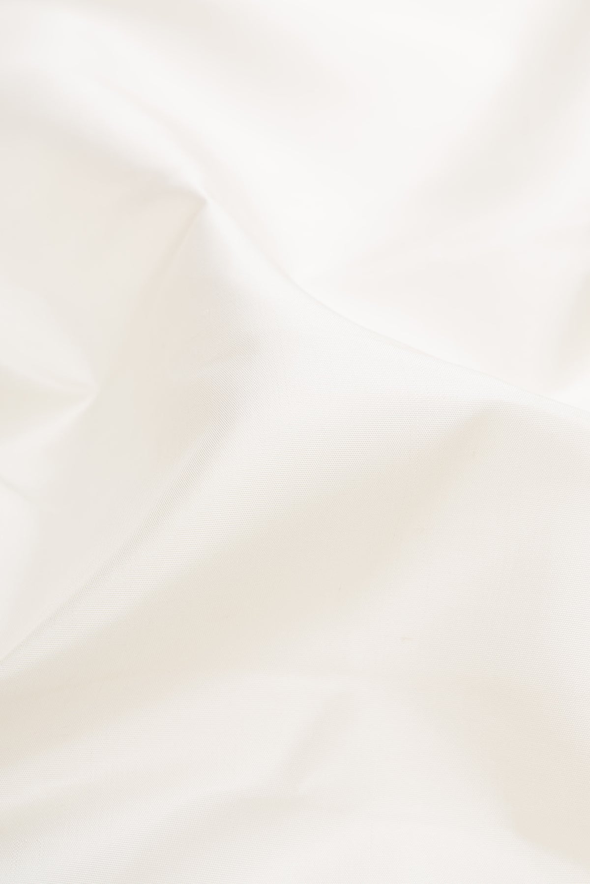Close up of Pure Silk Pure Zari White Kanjivaram Saree with Plain Body and Temple Border.  displaying folds