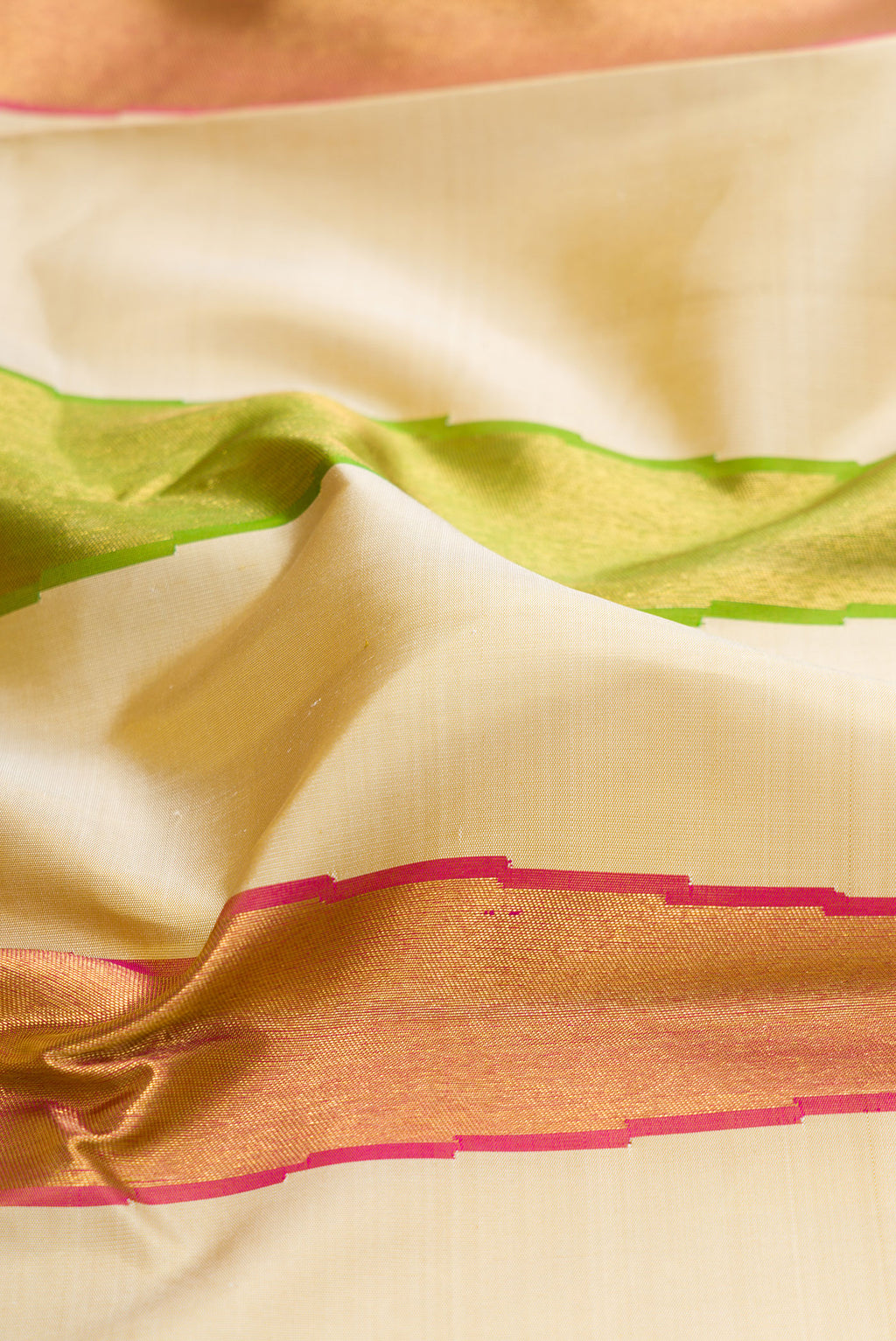 Close up of Pure Silk Pure Zari Sandal Dual Tone Kanjivaram Saree with Plain Body and Temple Border.  displaying folds