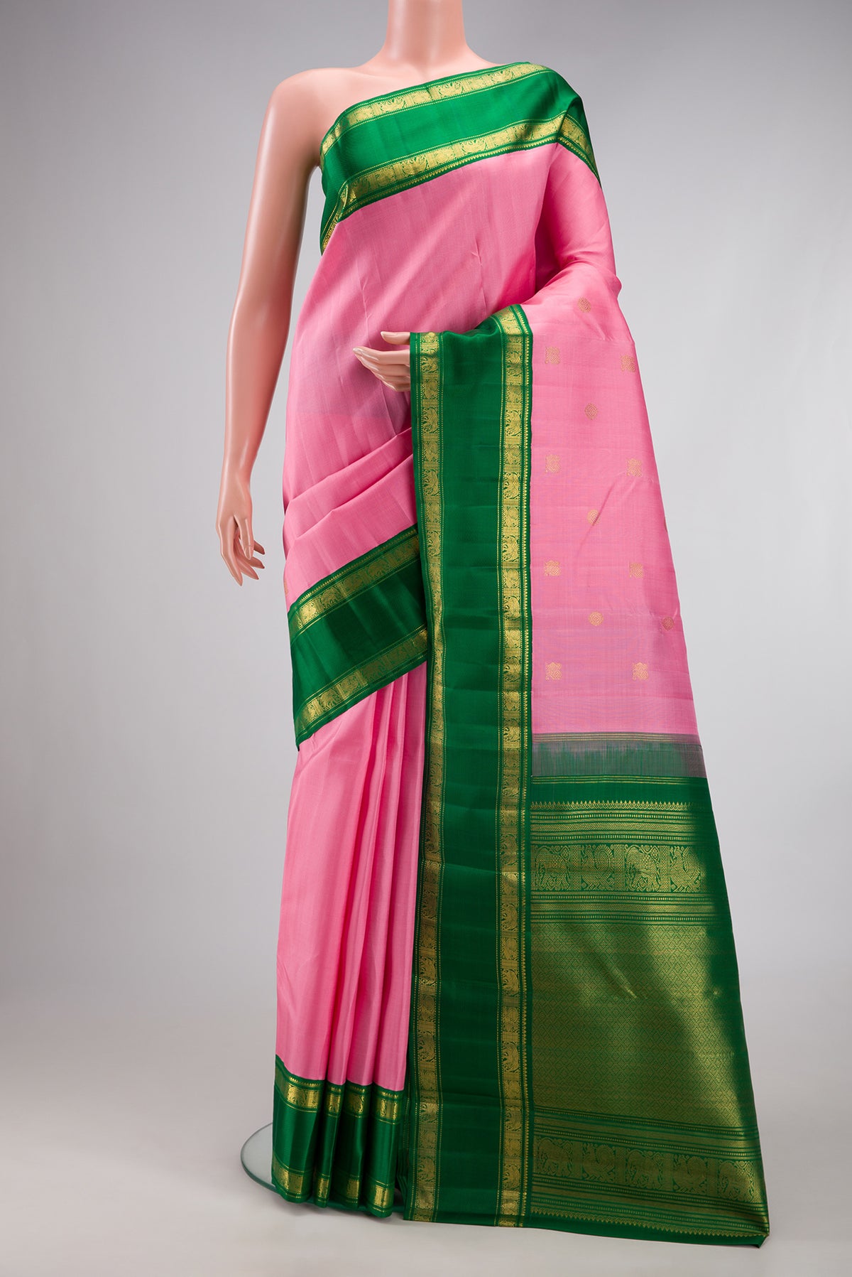 Pure Silk Pure Zari Rose pink Kanjivaram Saree with Zari Butta on the body and Zari Border.  displayed on a mannequin